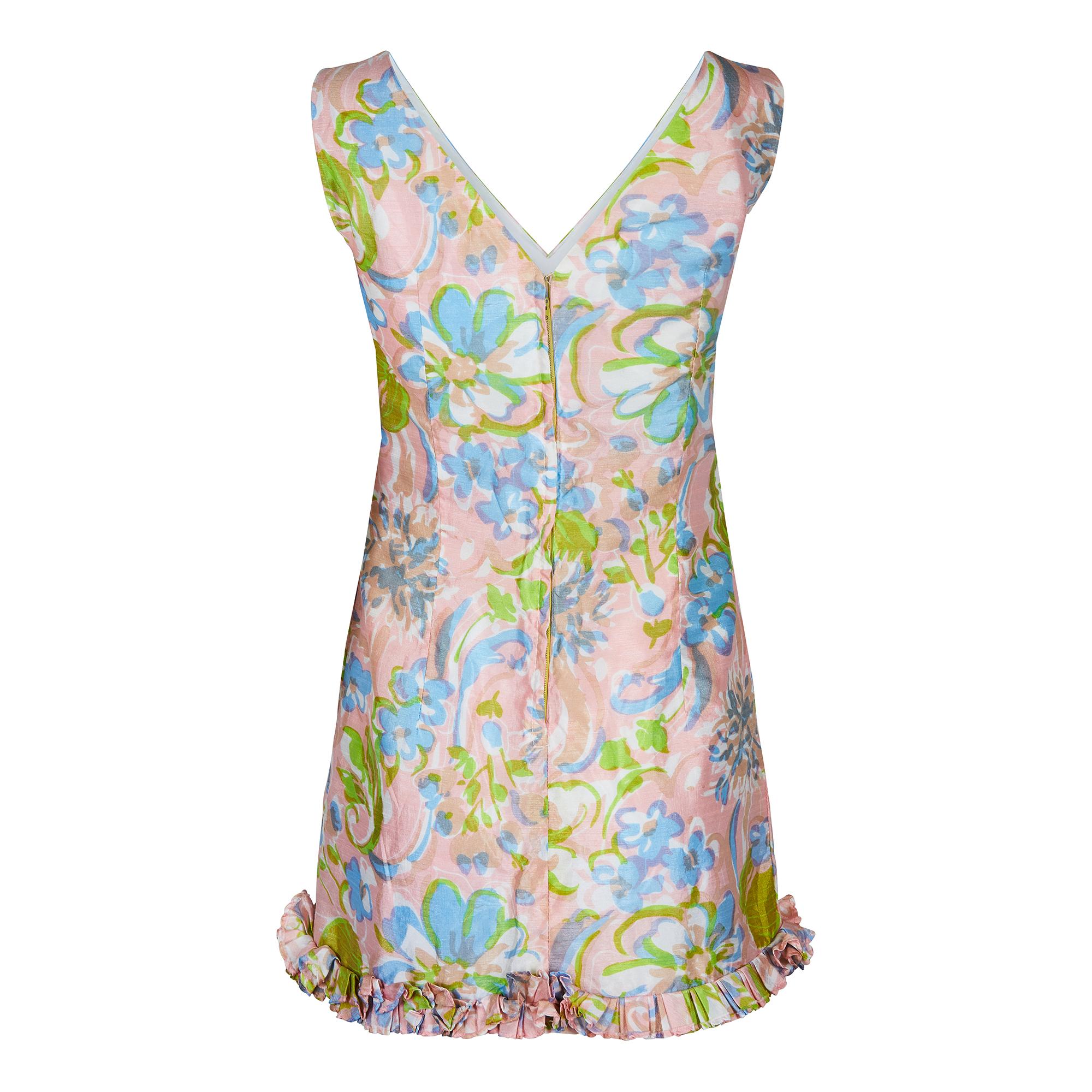 This is a good example of 1960s summer wear by quality British label Blanes. It has a very attractive abstract and painterly floral print in pastel hues of pink, green and sky blue. There are some great design features on this dress such as the