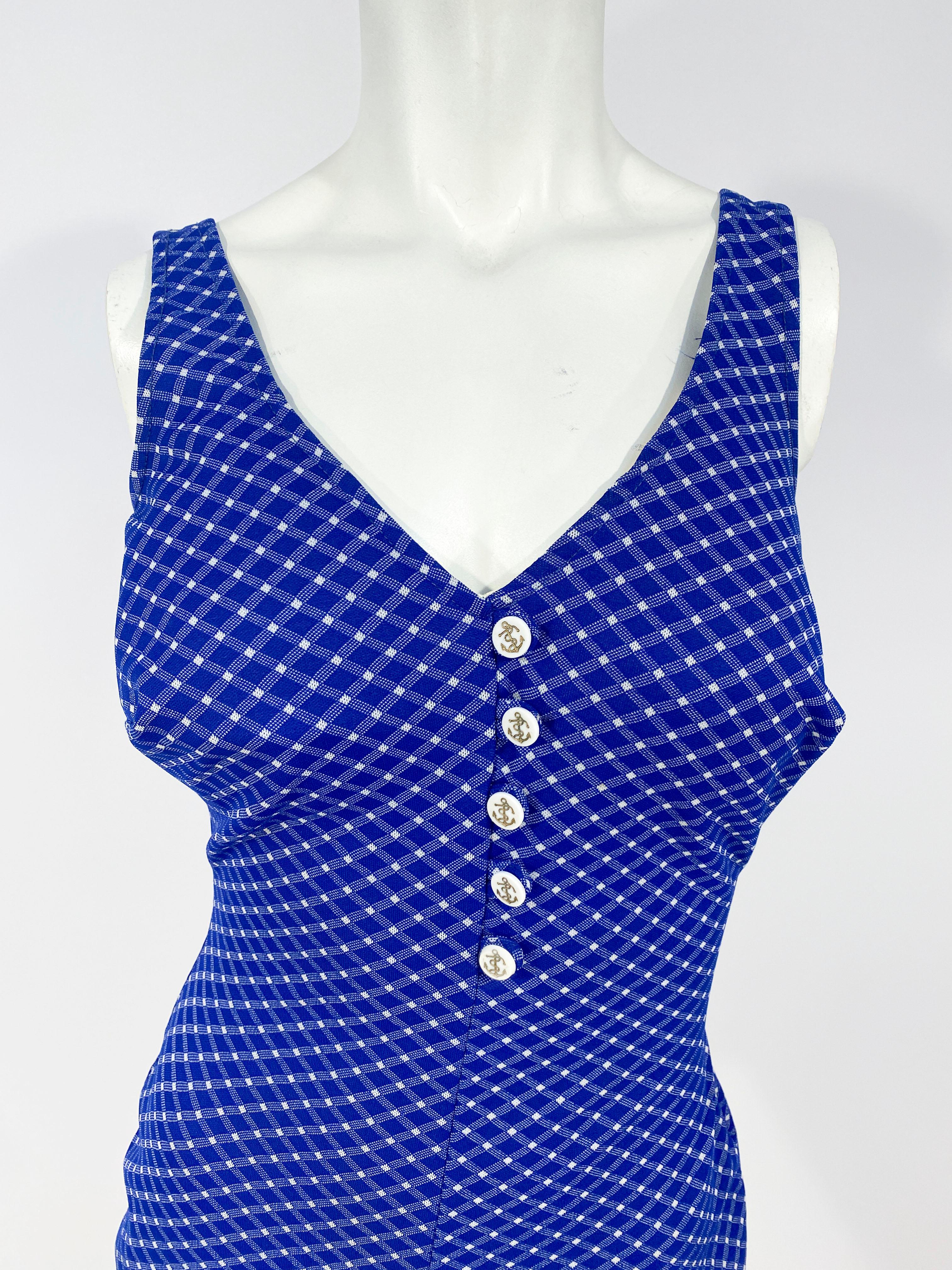 1960s blue and white gingham pattern bathing suit decorated with gold painted anchor buttons and a plunging backline. This piece has a builtin bra for support and the textile has ample stretch to accommodate a wide range of sizes. 