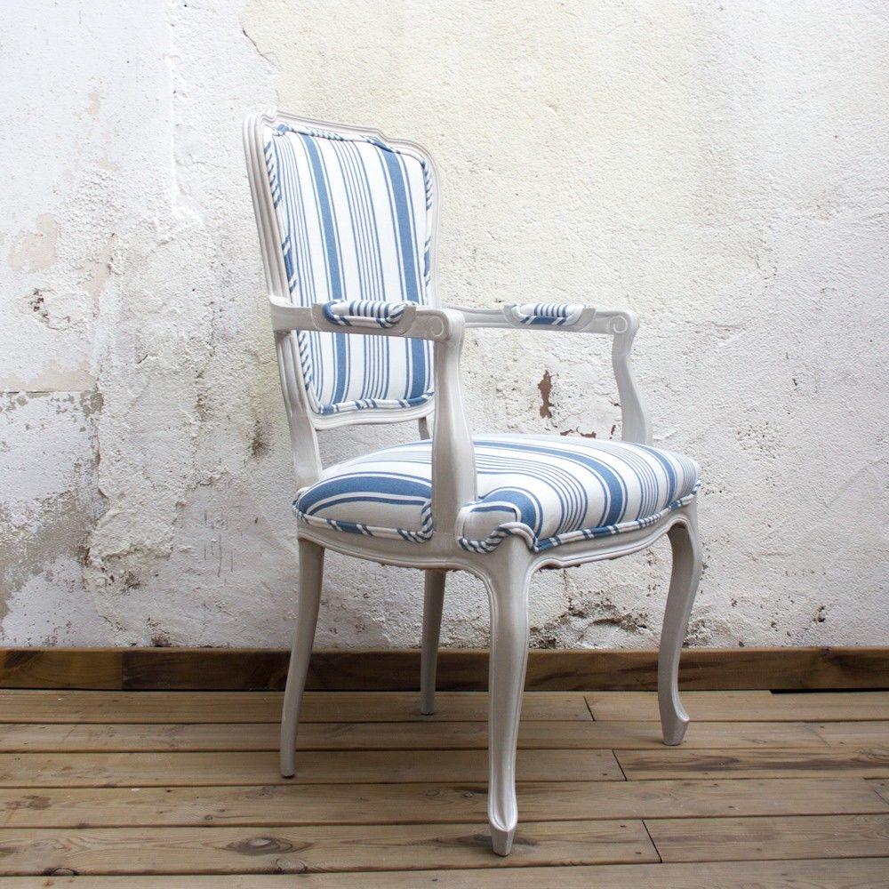 This armchair has a Baroque style structure with a mid-century feel. The mix of styles and the addition of a Classic blue and white striped fabric make this armchair a stand out piece. The curving lines of the chair base has been finished in a