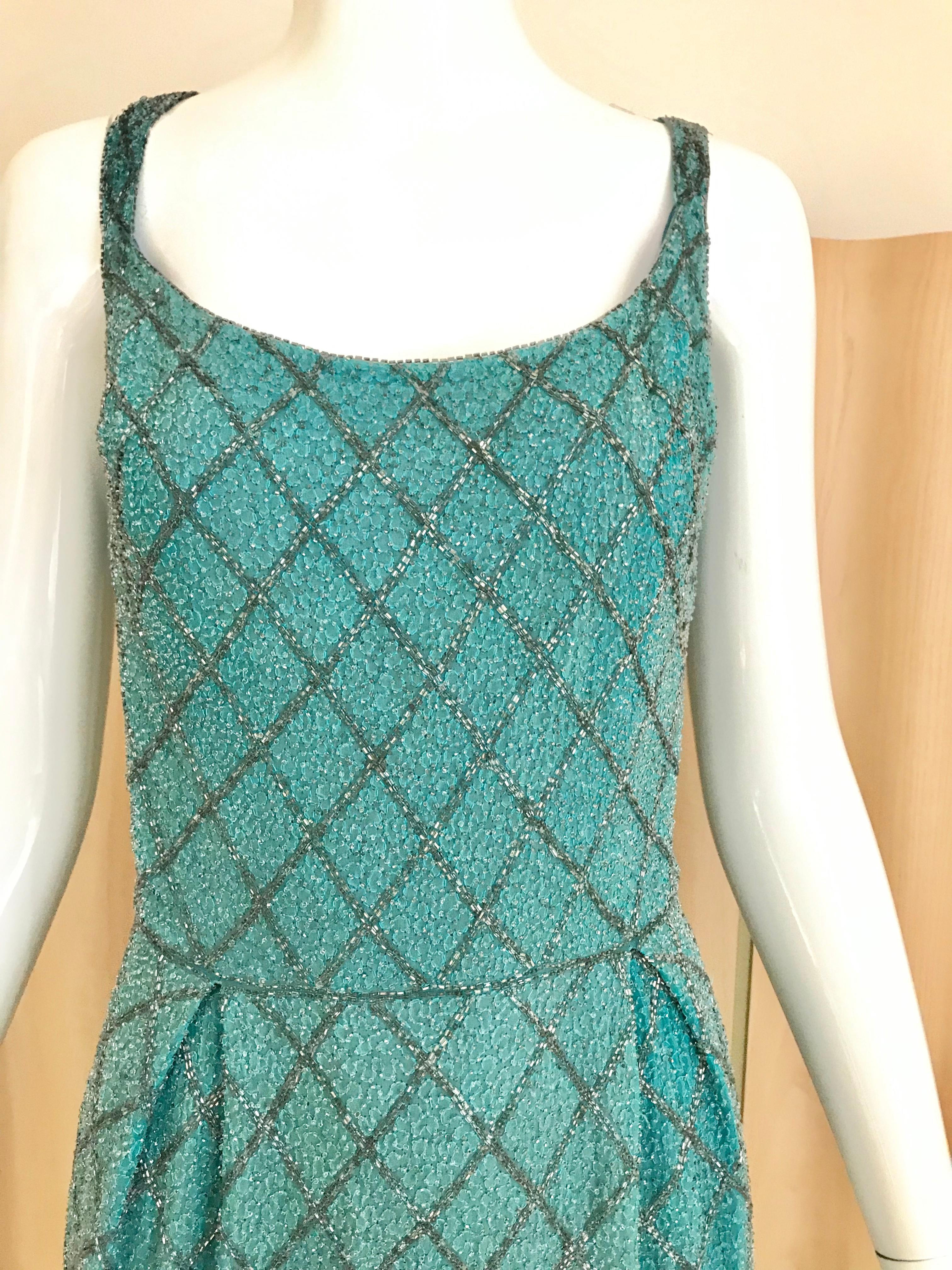 Timeless 1960s Blue silk Wiggle dress in silver beads and grey beads
Size: Small or fit 0/2/4
Bust: 34.5 inches / Waist: 26 inches/ Hip: 36inches/ Dress length: 40 inches