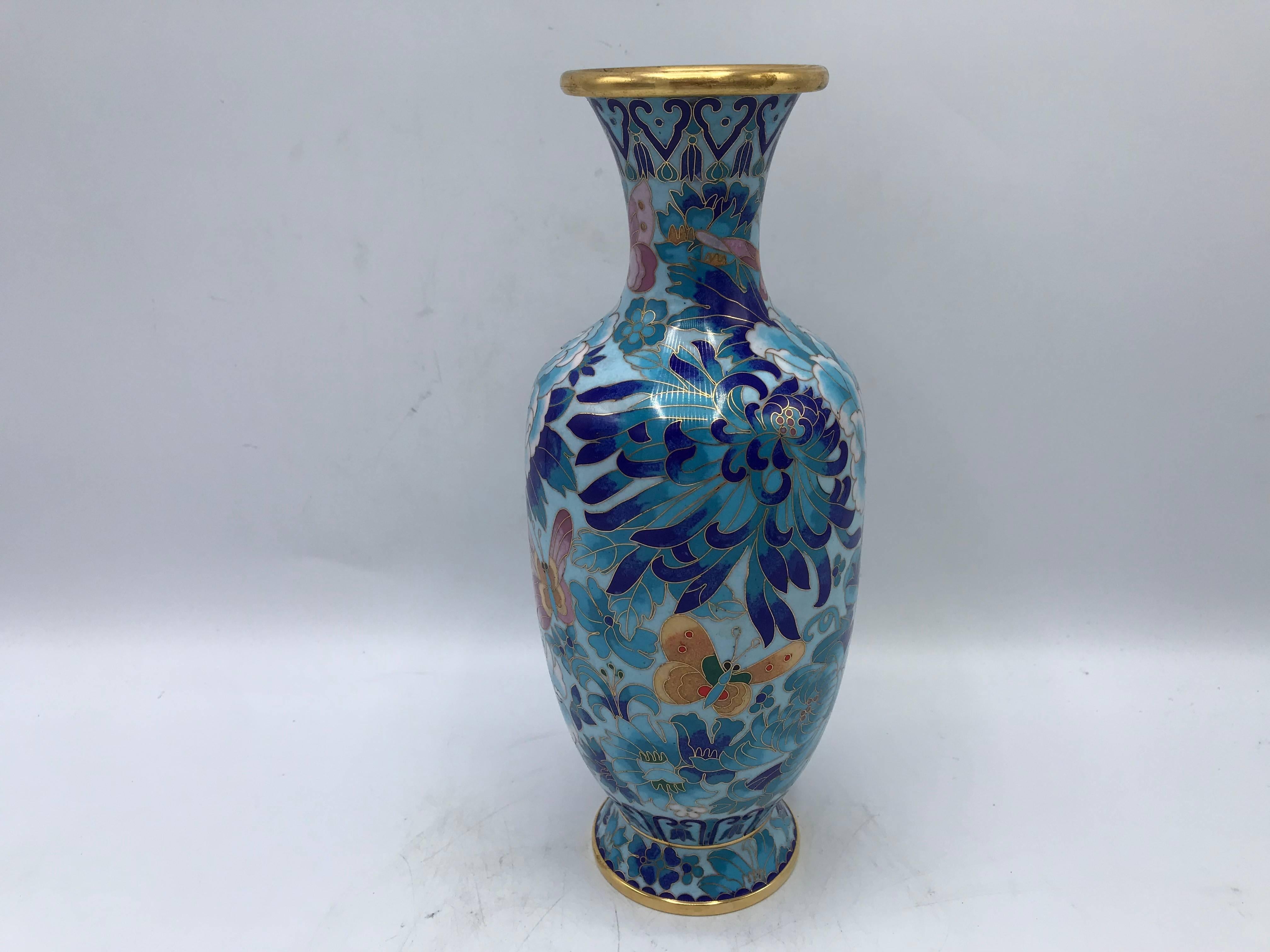 Listed is a stunning, 1960s cloisonné vase. The piece has gorgeous shades of blue, complimenting the all-over peony and floral motif.