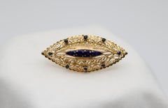 A 1960s Blue Enamel, Sapphire & Gold Brooch