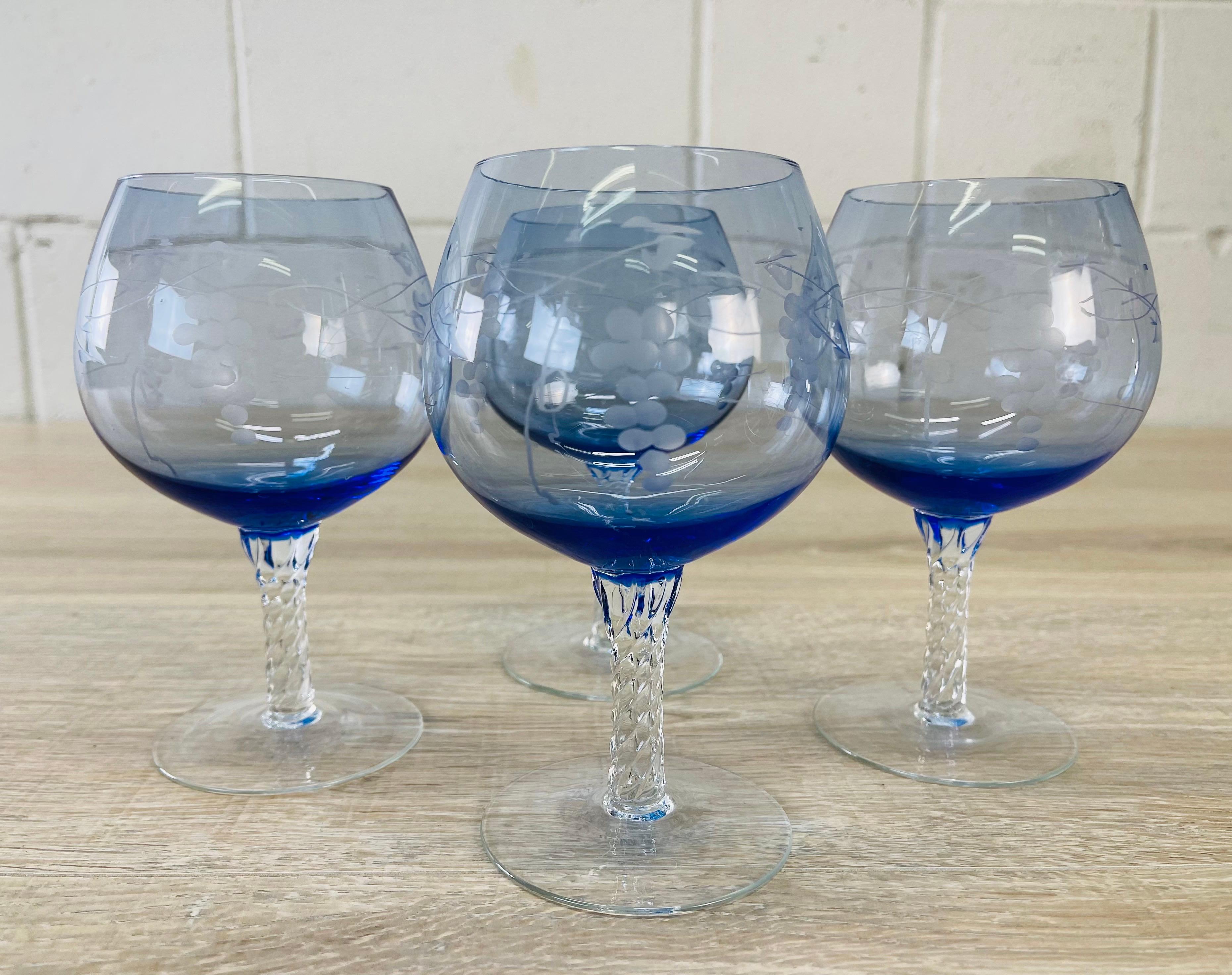 Vintage 1960s set of four blue glass brandy snifters with a grape leaf design and twisted stems. No marks.