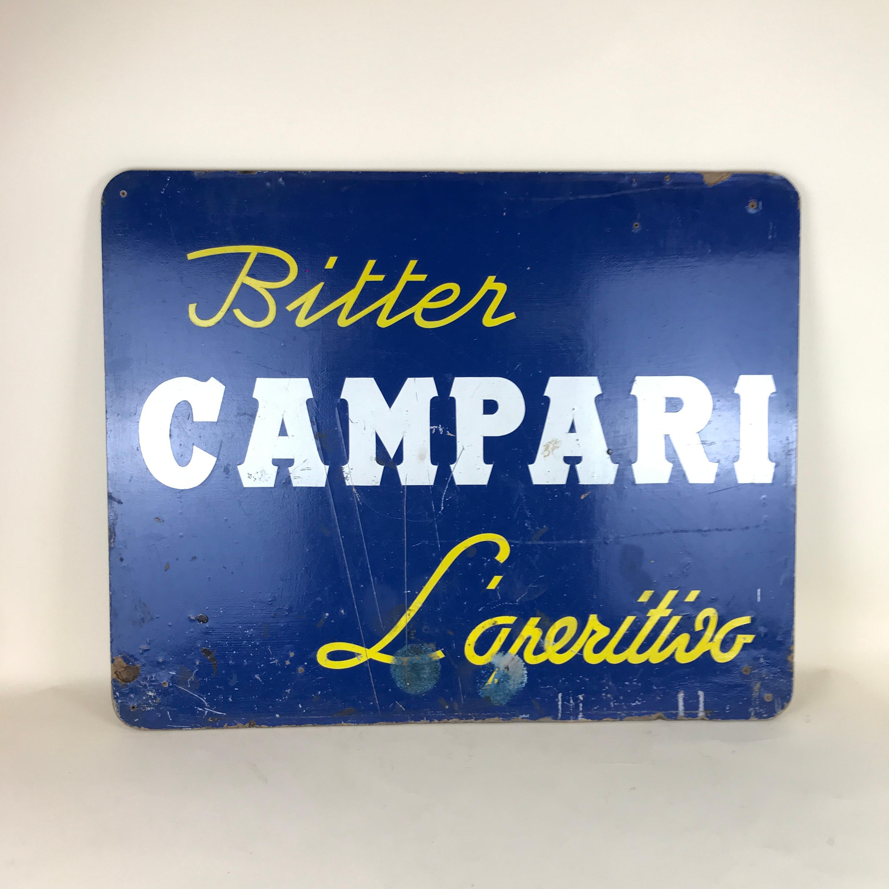 This vintage hard cardboard sign of Bitter Campari L' Aperitivo with yellow and white letters on blue background was produced in the 1960s in Italy.

Collector's note:

Campari is an Italian alcoholic liqueur, considered an apéritif obtained
