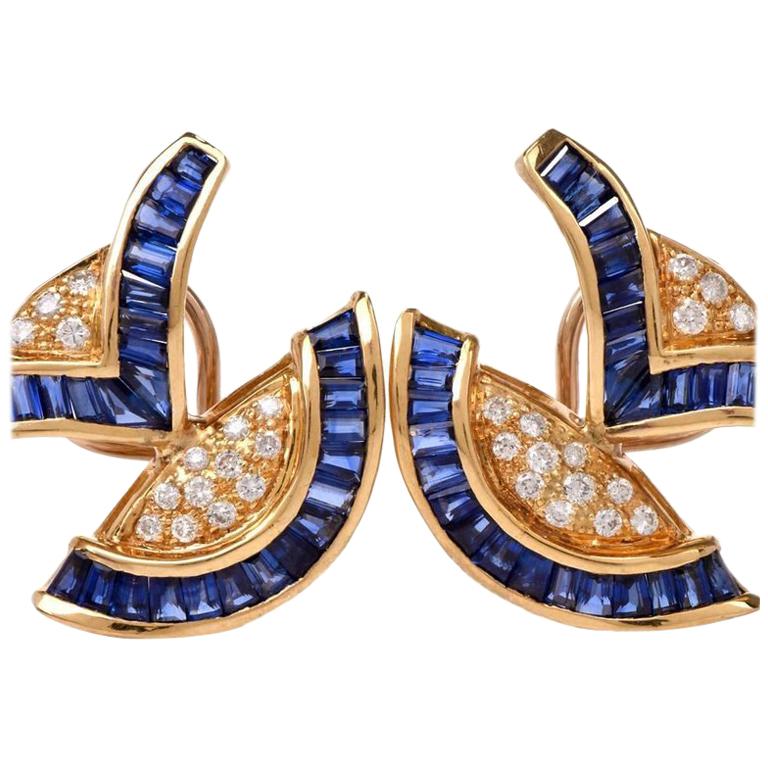 These exquisite 1960's  earrings with tapered baguette blue sapphires ad pave diamonds are crafted in 18 karat yellow gold, weigh 10.5 grams and measure 20 x 22 mm. Designed as a combination of color-contrasted crescent shape and 'V' shape profiles,