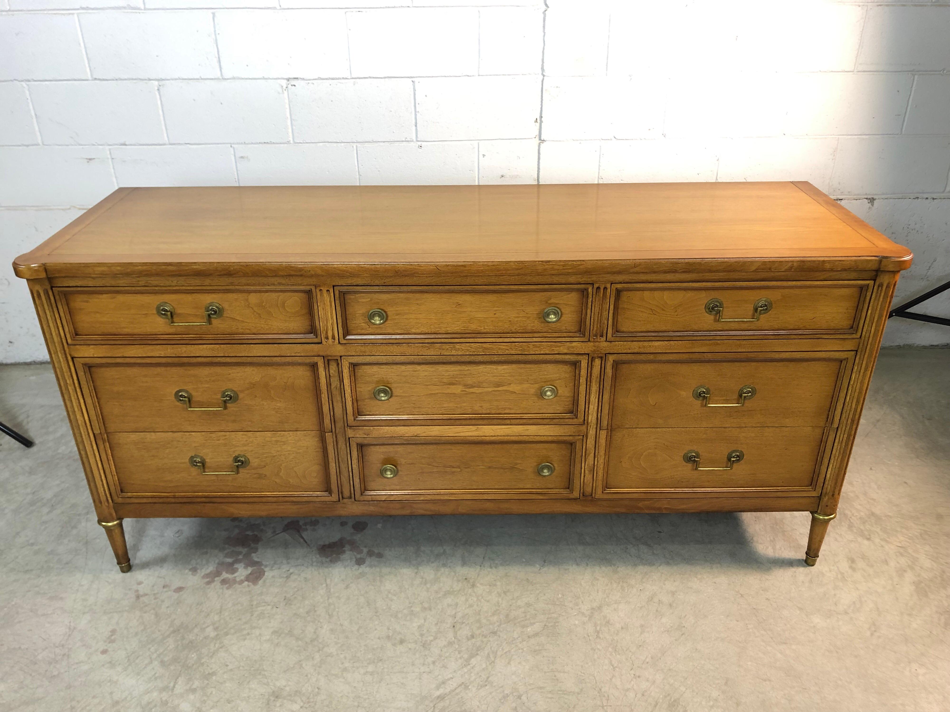 Vintage 1960s Bodart furniture Sheridan low mahogany dresser.
The dresser has nine drawers for storage and comes with brass pulls and brass accents around the feet. The dresser is made of bleached mahogany and the interior is made of oak wood.