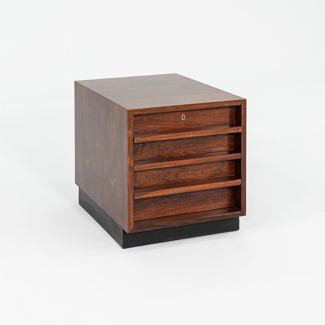 This is a Brazilian Rosewood Four Drawer Cabinet, designed by Bodil Kjaer for CI Designs in 1959. The piece was produced by E. Pedersen & Son in Denmark in the 1960s. It features a wood frame with a Rosewood exterior. The piece has been fully