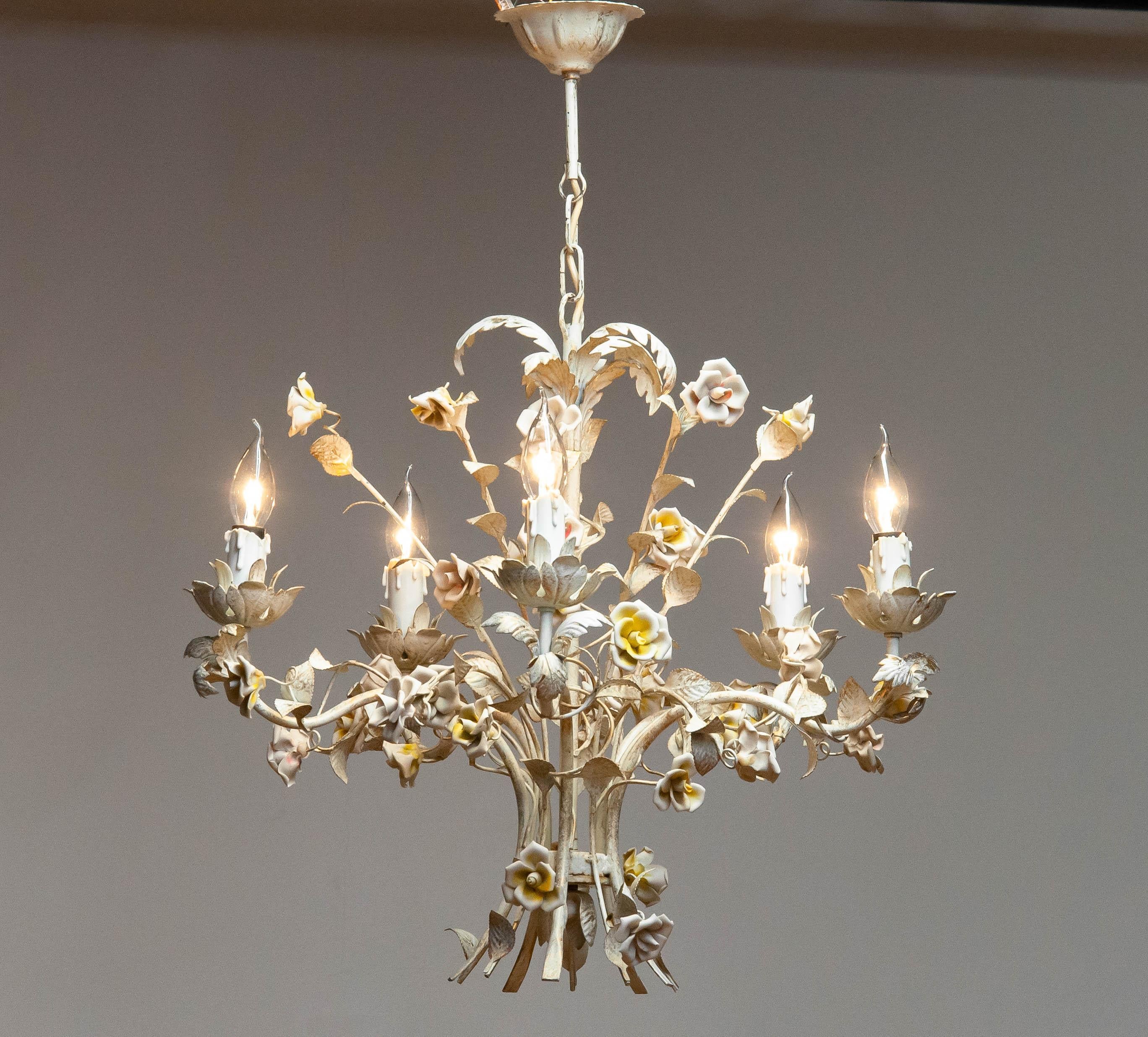 Absolutely beautiful hand painted, pastel colors with golden details, chandelier made in the 1960s in Italy. Soft pastel colors ar used to give this chandelier her chic appearance and character.
The flowers on the chandelier are made of
