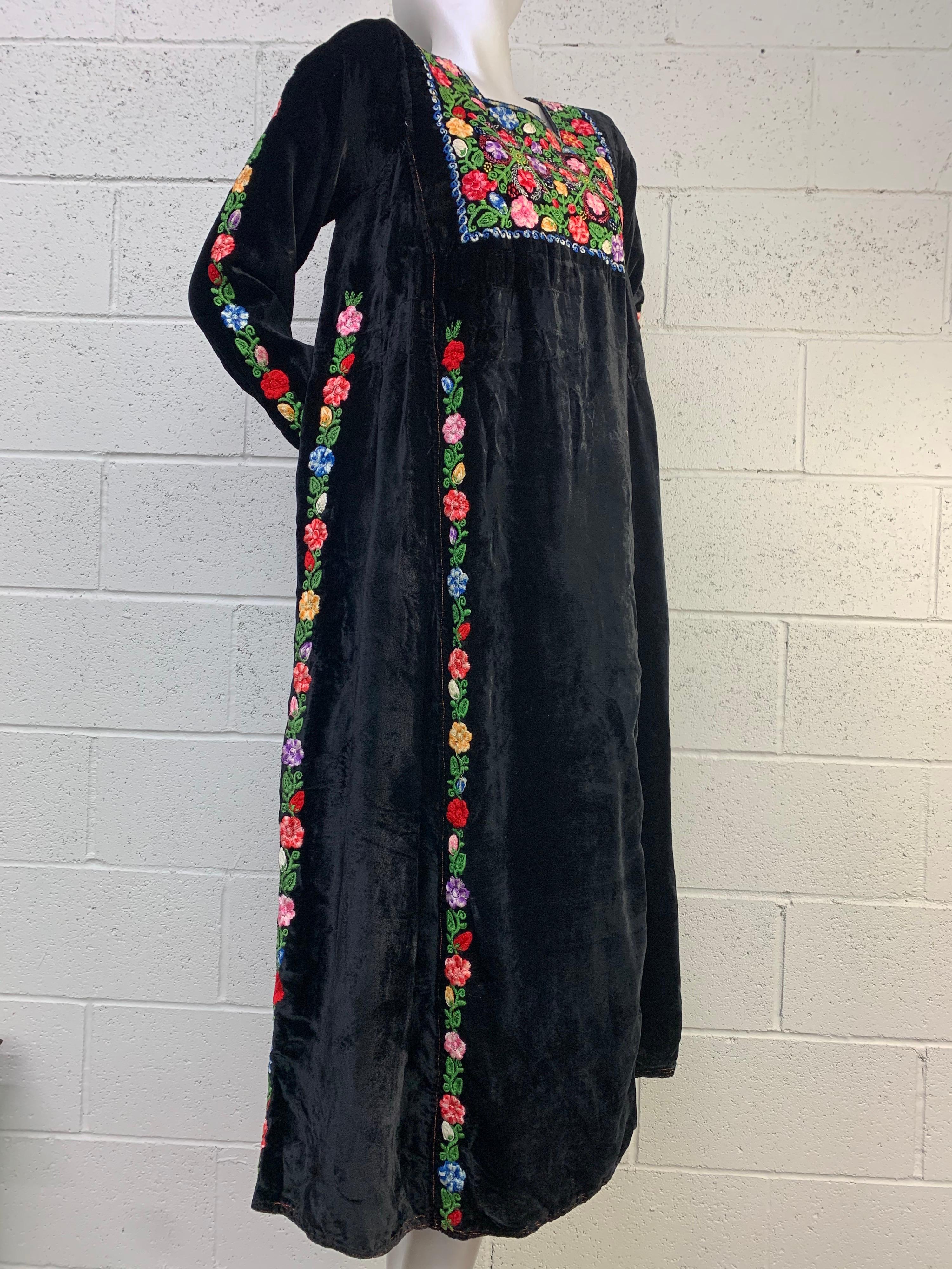 An imported 1960s Boho, Renaissance-revival styled black velvet maxi dress with heavily embroidered floral panels at front bust and streaming down each side. Size 6. Think Woodstock Guinnevere groove.
