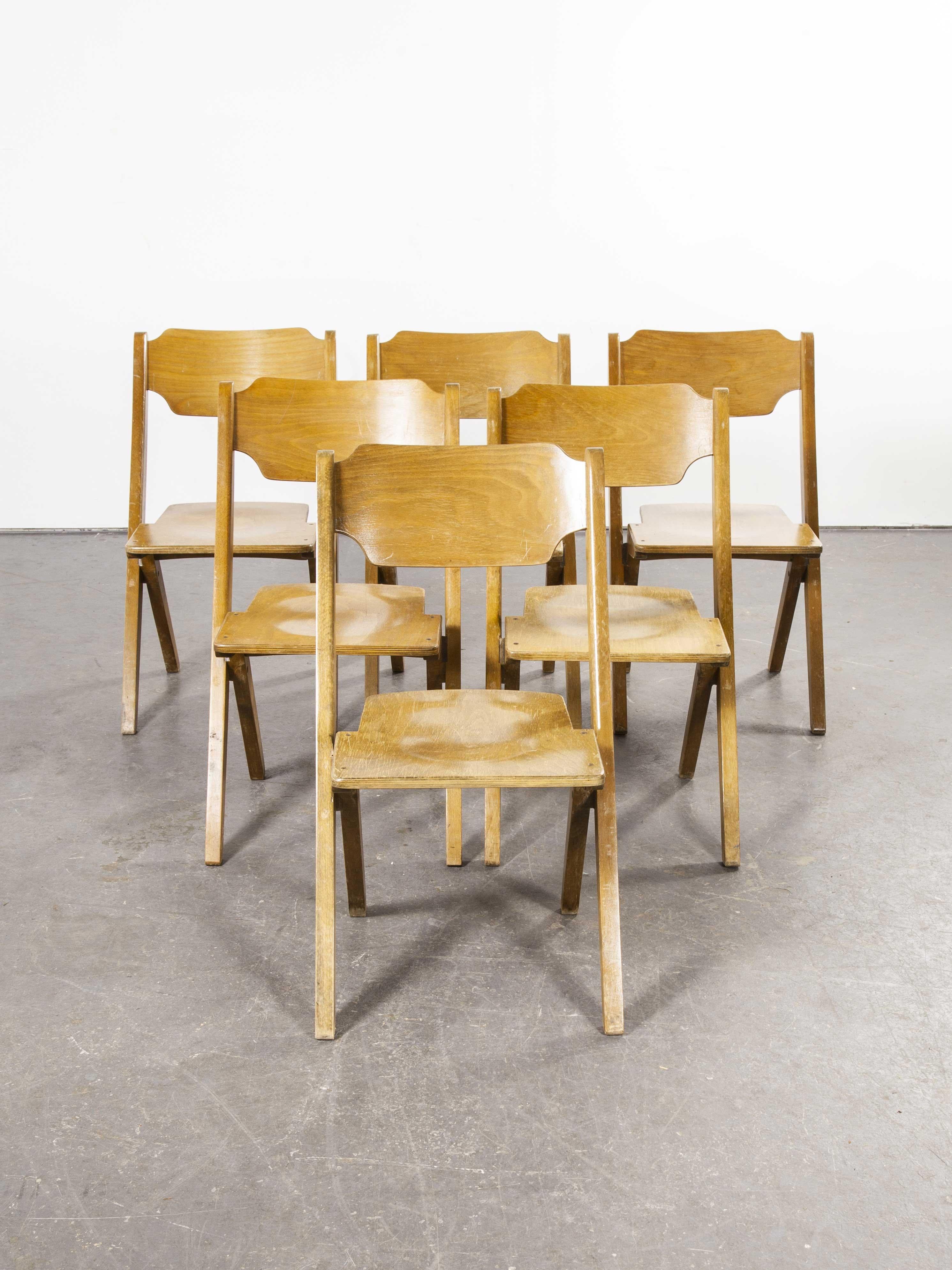 1960s Bombenstabil stacking beech dining chairs, set of six. We believe these chairs were made by Bombenstabil in Germany in the 1950s. They have the aesthetic of a folding chair but they are rigid fixed chairs that by their design stack incredibly
