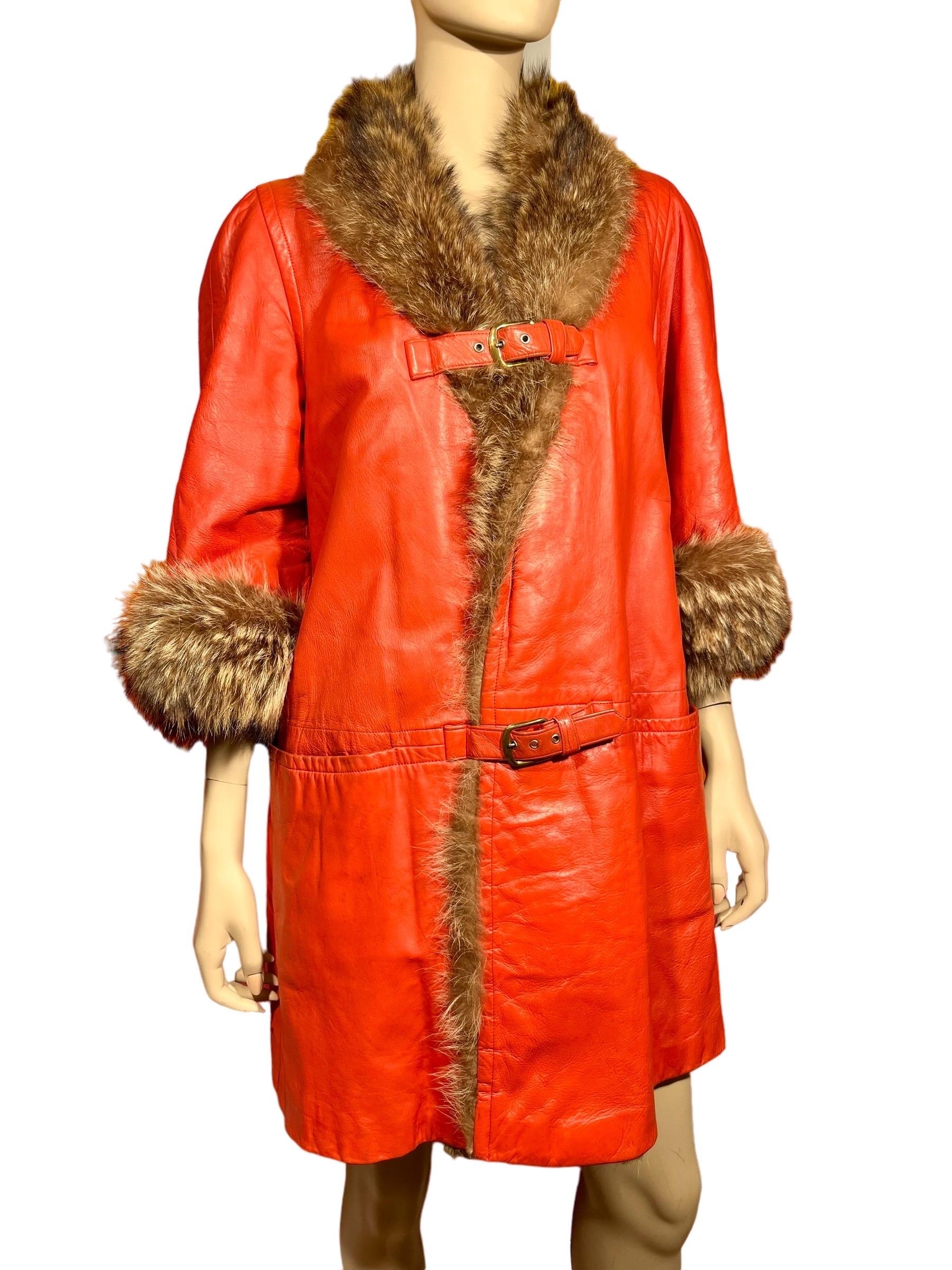 Incredible 1960’s Bonnie Cashin for Sills beautiful burnt orange leather & fur coat. This gorgeous deep orange leather jacket has dark brown natural raccoon fur around the collar, three-quarter sleeves, and down the opening serving not only for