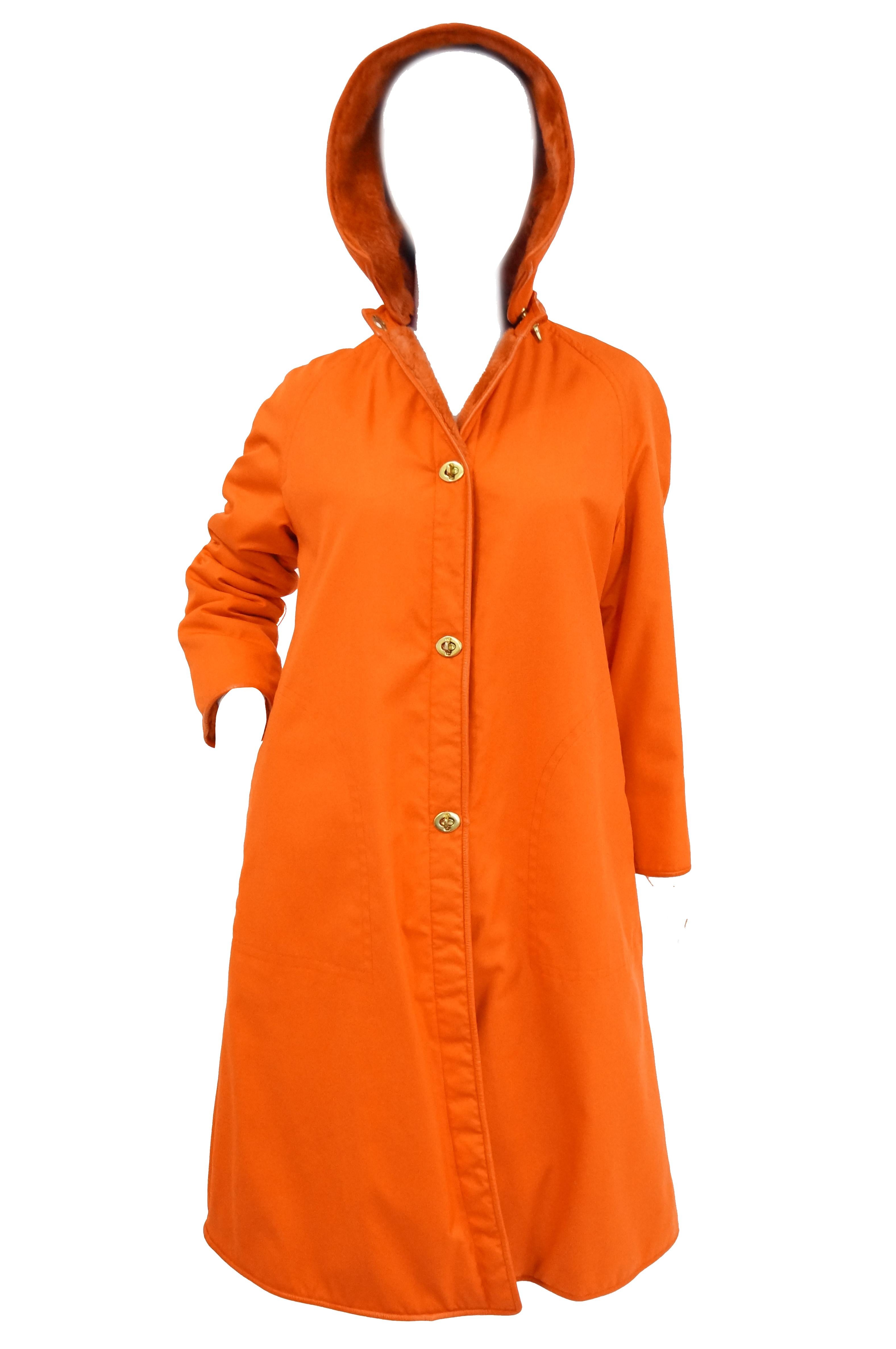 Amazing bright orange Bonnie Cashin canvas and leather coat and skirt ensemble! The skirt is a classic A - line that falls around the knees, with a narrow waist band and light pleating. The jacket is knee - length, with a loose silhouette, rounded