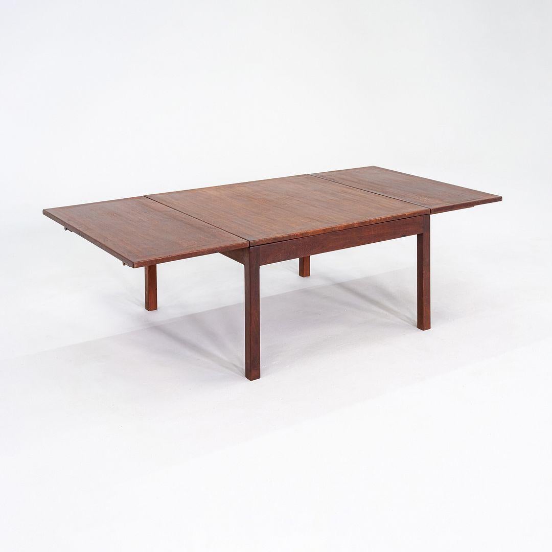 This is a drop leaf coffee table designed by Borge Mogensen for Fredericia Stolefabrik. This particular example was produced in Denmark in the 1960s. The table is crafted in solid teak and features a rectangular top with hinged drop leaves on both