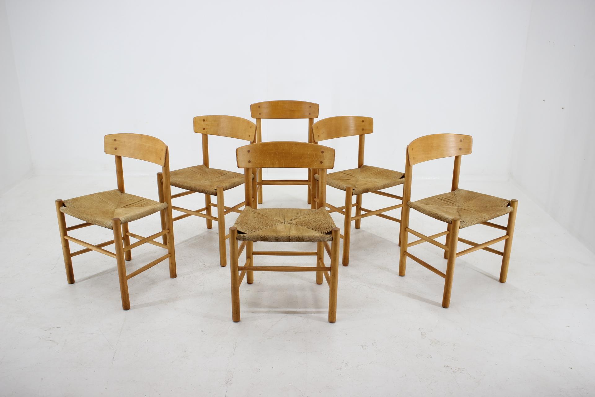 The frame of each one is made from stained beech wood and beech veneer. Partly renovated. The paper cord seats have some signs of use due to age.