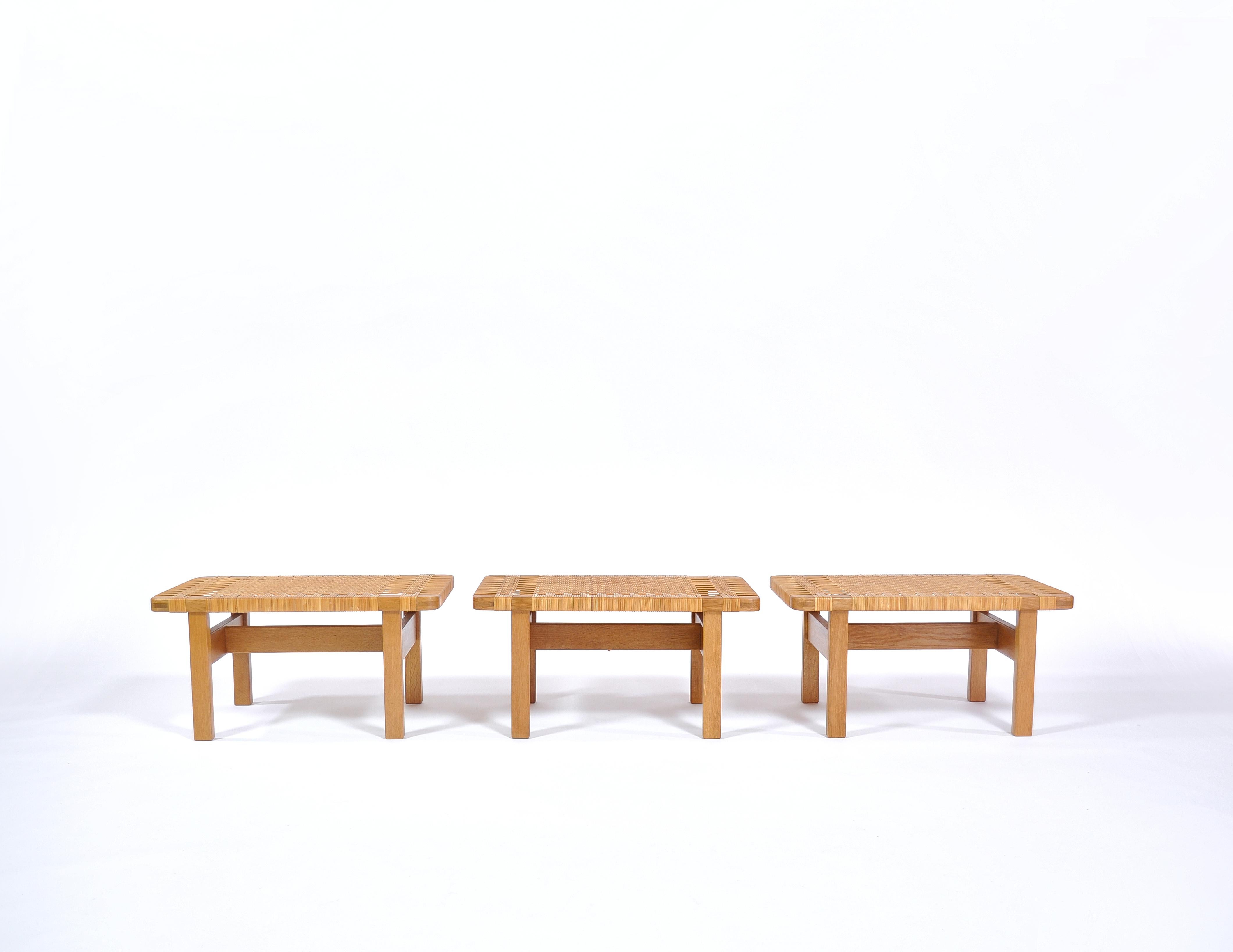 Beautiful Danish modern benches in solid oak and handwoven rattan cane by Danish architect Borge Mogensen. They can be applied both as low side tables and as benches. Mogensen made the design in the 1950s and it was made in different sizes by