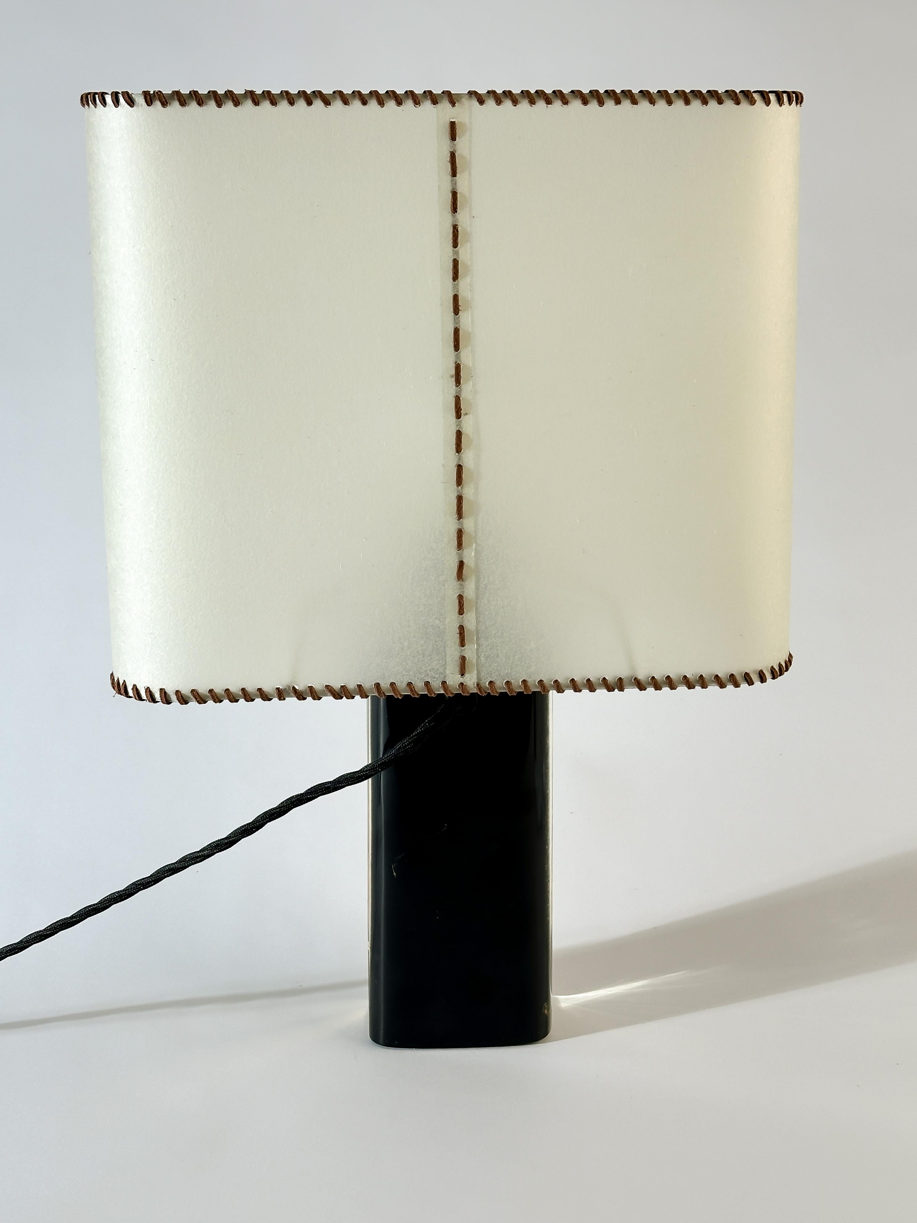 A distinctive 1960s resin table lamp evocative of Pierre Giraudon’s experimental material artistry. The lamp base features a suspended botanical arrangement—real dried flowers in vivid hues—encased within a block of crystal-clear resin. The scene is