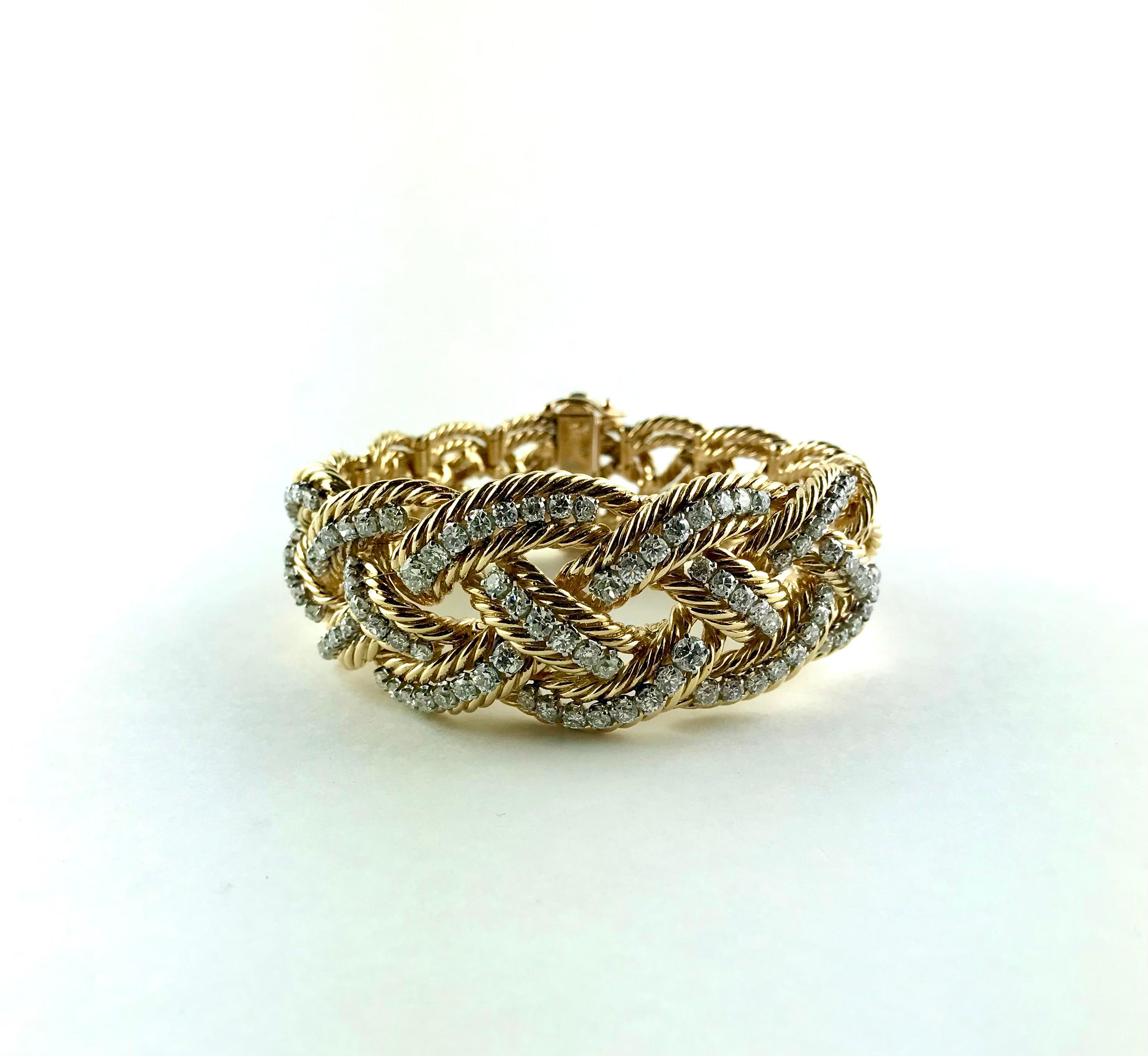 Extremely chic 1960's French 18 karat Yellow Gold and Platinum Bracelet with Diamonds signed by Boucheron.
Designed as braided segments of twisted Yellow Gold rope, enlighted across the top with 7 cts prong-set arcs of high quality round-cut