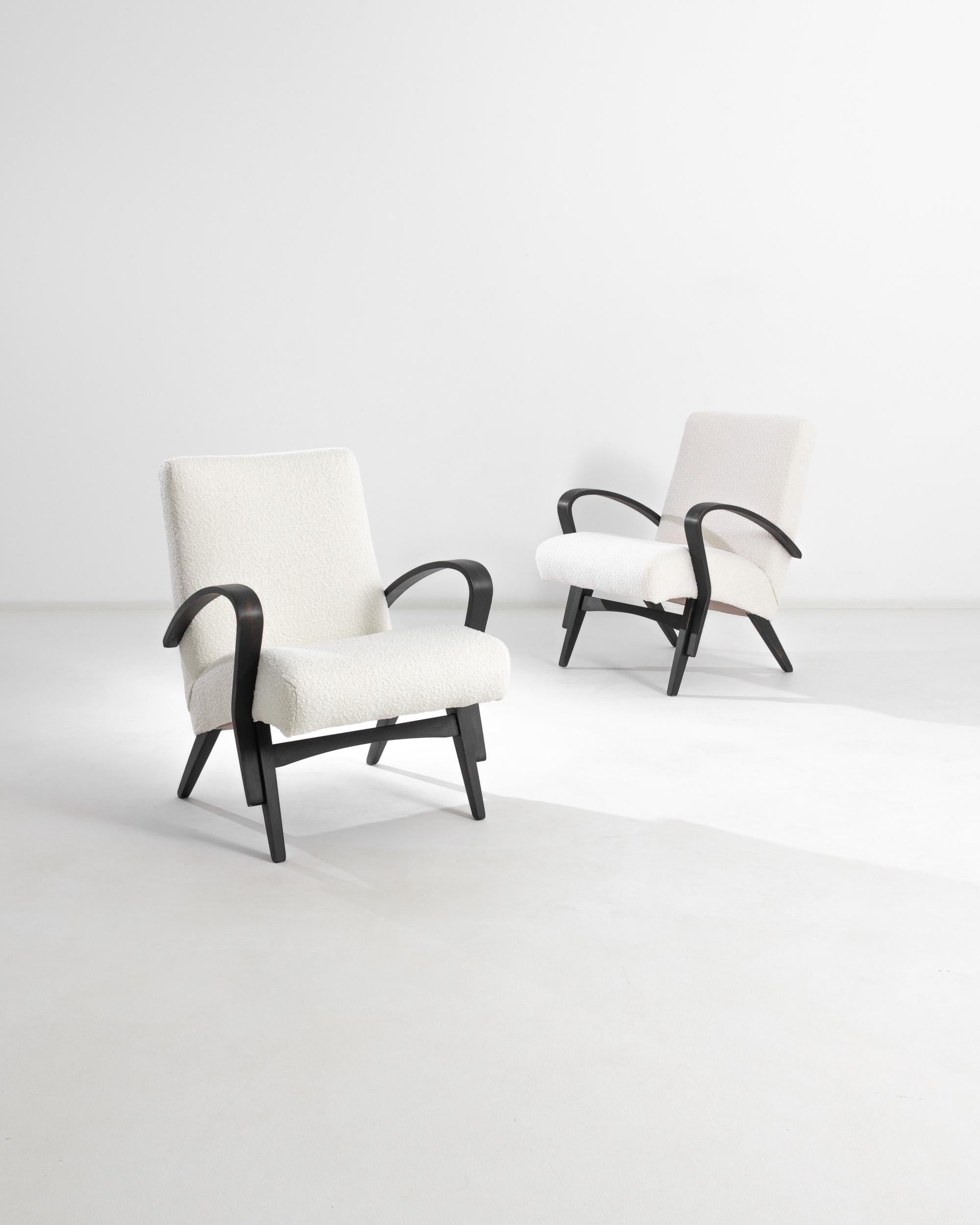 A pair of upholstered armchairs by Czech furniture manufacturer Tatra. Attributed to designer František Jirák who is known for his striking case pieces and wall units, and for playful compact furniture that distinguish Czech Design of the mid-20th