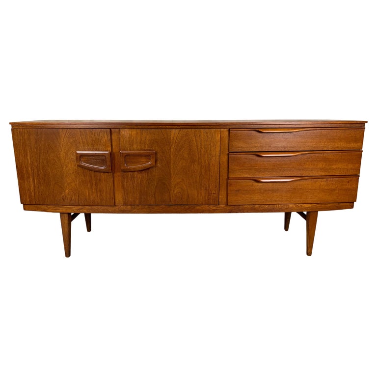 Danish modern style bow front teak credenza with centre fold down laminate bar area.