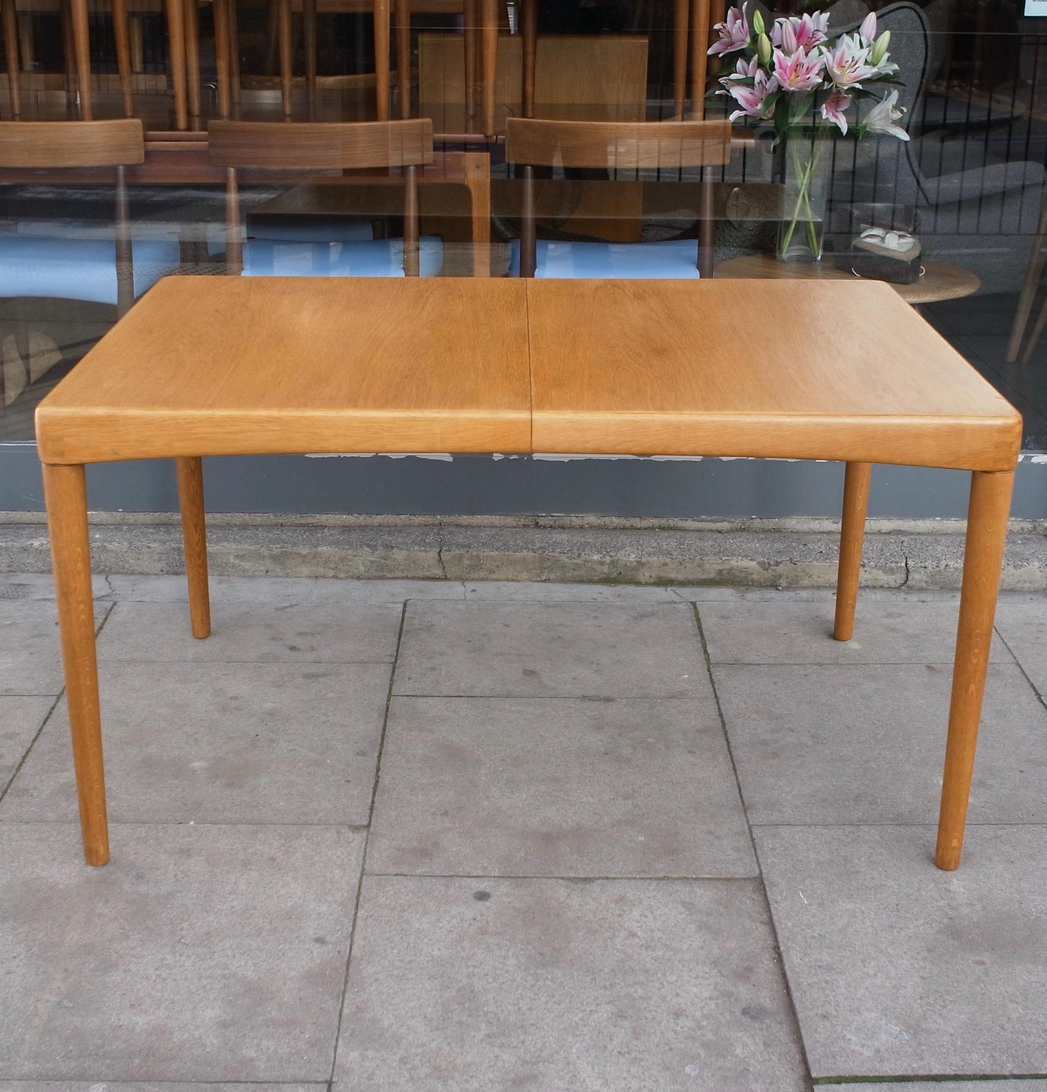A very beautiful, rare and stylish vintage rectangular Oak, extending Danish 1970s dining table, set on solid Oak tapered legs. This table was designed by HW Klein and produced by Bramin, it includes a 60cm extension leaf, which can be stored