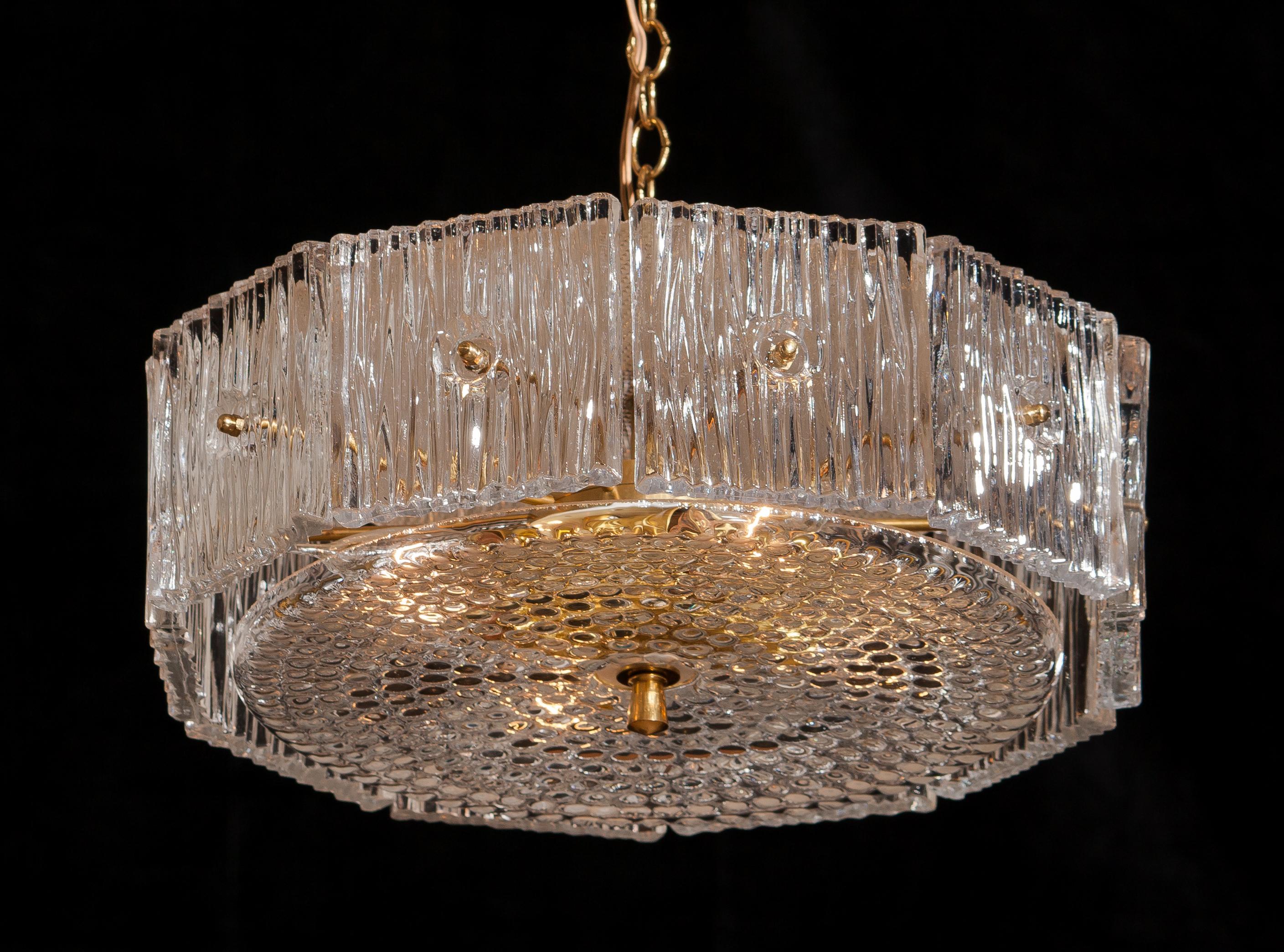 Brass and clear crystal chandelier or pendant designed by Carl Fagerlund for Orrefors, Sweden.
This chandelier or pendant is in excellent condition and technically 100%.
Wired for 220 / 110 volt.
Period: 1960.
The dimensions of the crystal parts