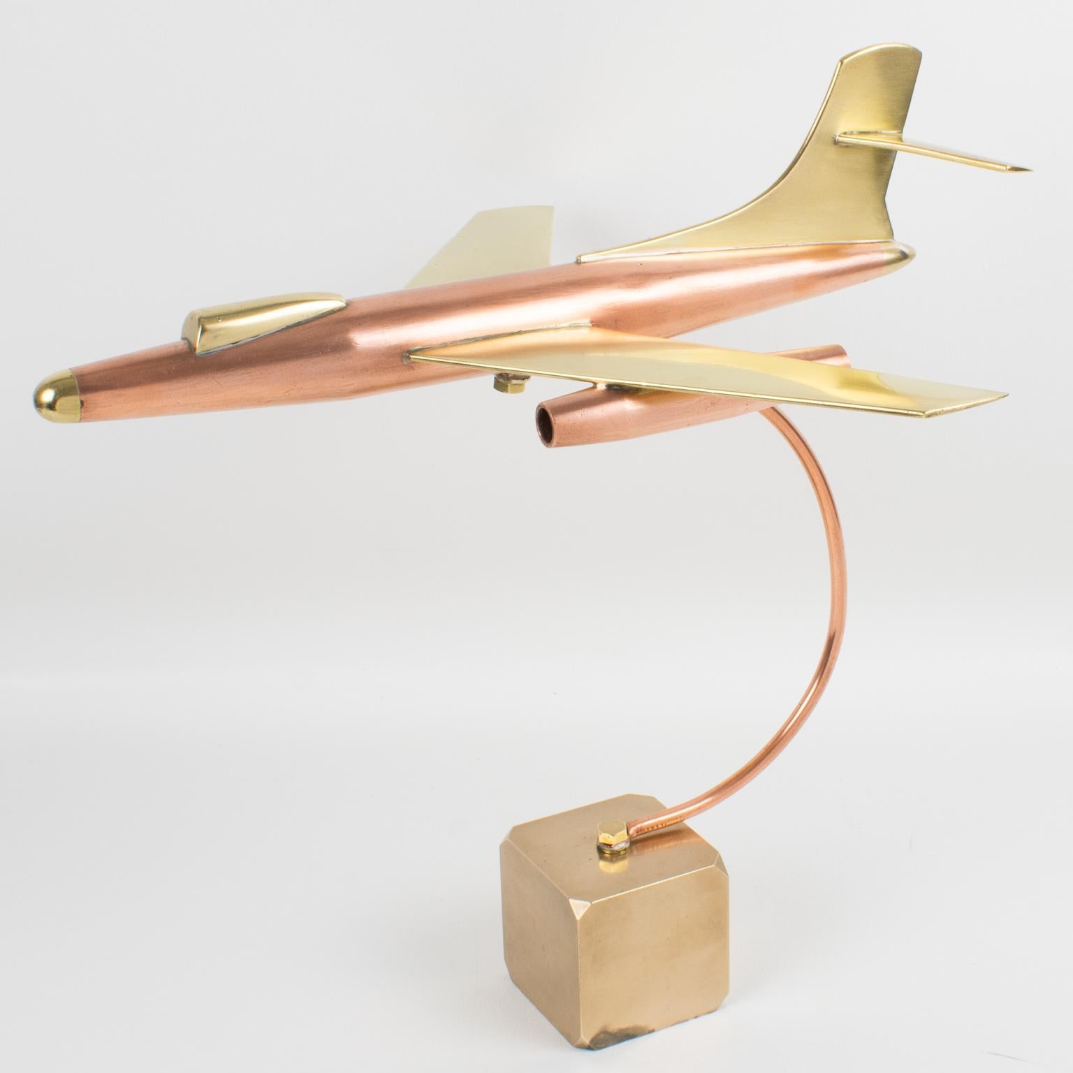 Stunning large brass and copper airplane model, made in France, circa 1960. Featuring an impressive all-metal jet plane model on a thick solid brass cube base. Great desk accessory for aviation collectors and lovers. 
Measurements: 
Overall: 11.82