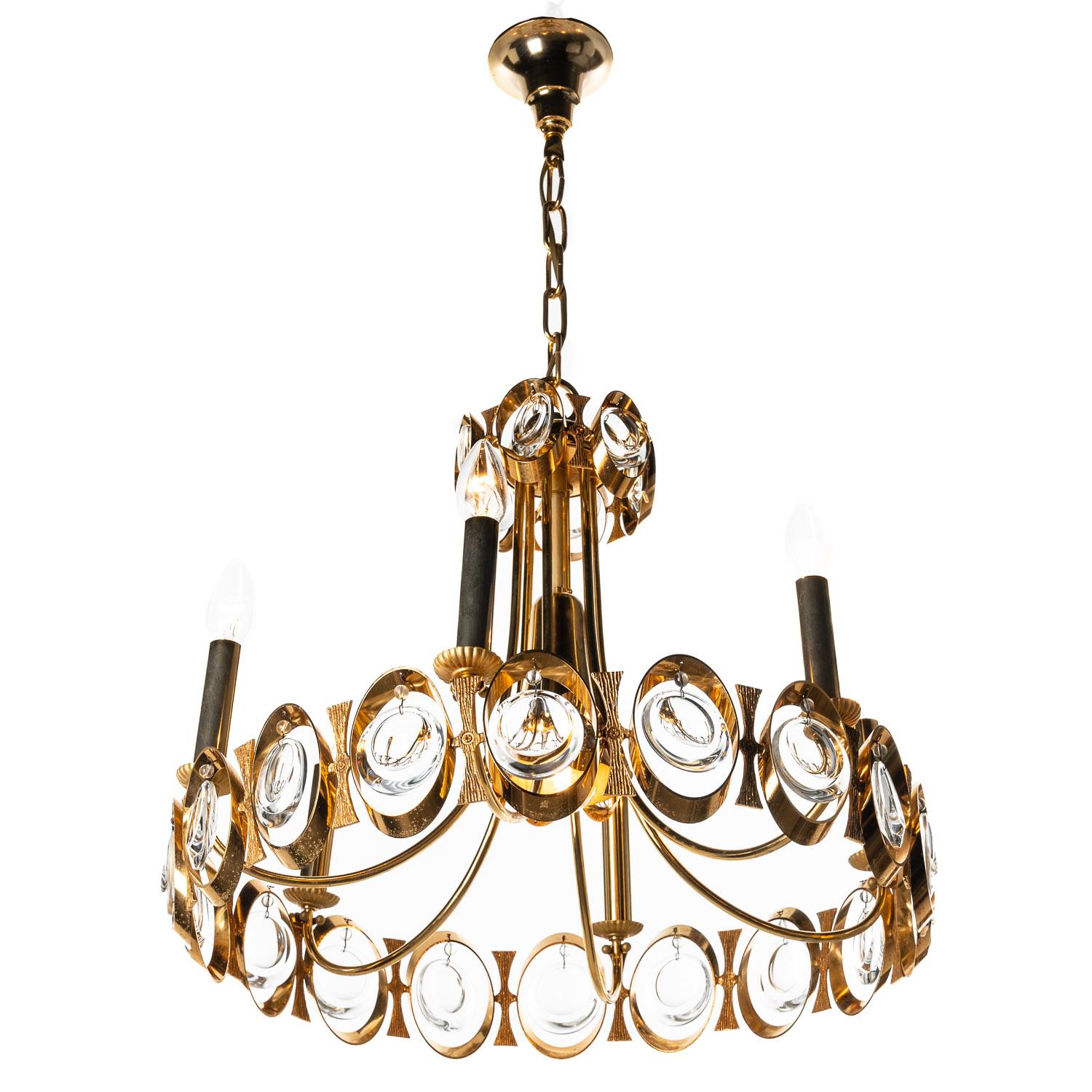 This is a stunning examples of a 1960s Palwa piece, the opulent blend of crystal glass and gilt-brass make this a truly special. The seven-light arrangement illuminates the crystal glass work in a way that grabs the attention. 
