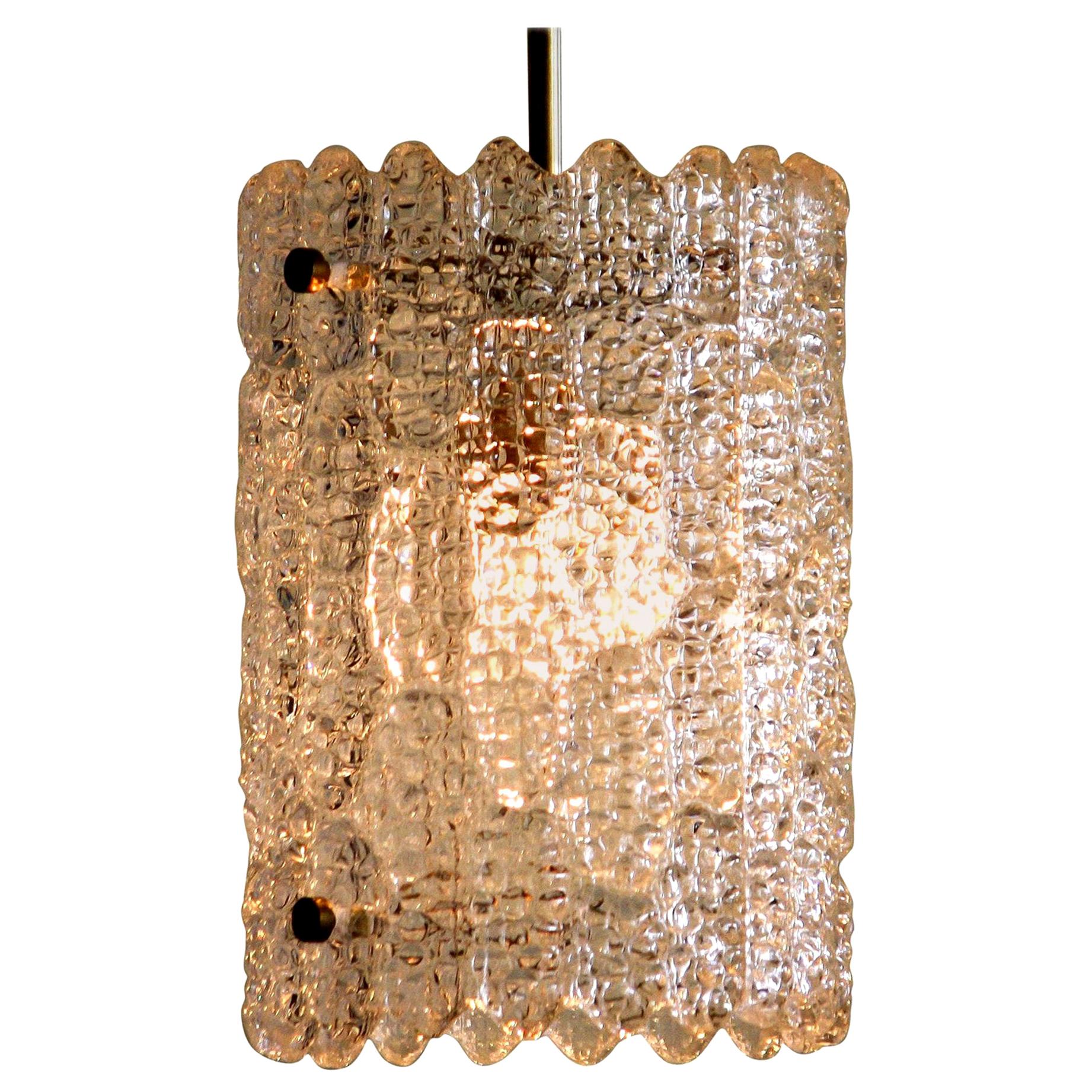 Beautiful pendant designed by Carl Fagerlund for Orrefors, Sweden.
This lamp is made of brass with crystal glass and is in a very nice condition.
The textured glass reflects a wonderful light.
Period: 1960s.
Dimensions: H 25 cm, Ø 18 cm.