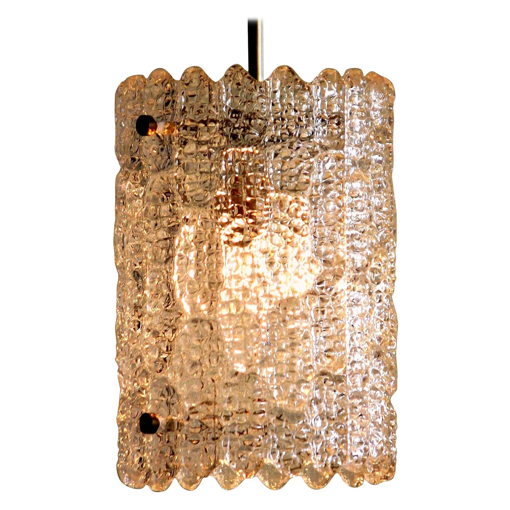Beautiful pendant designed by Carl Fagerlund for Orrefors, Sweden.
This lamp is made of brass with crystal glass and is in a very nice condition.
The textured glass reflects a wonderful light.
Period: 1960s.
Dimensions: H 25 cm, Ø 18 cm.