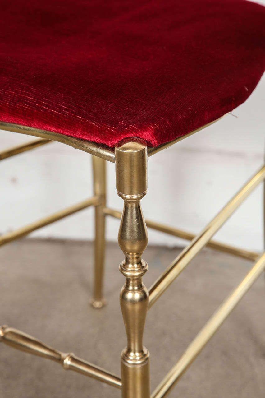 Pair of polished brass high back side chairs by Chiavari.
A wonderful handcrafted pair of polished brass side chairs with shapely crest rails and spindled backs and with red original velvet upholstery.
Designed by Giuseppe Gaetano Descalzi and