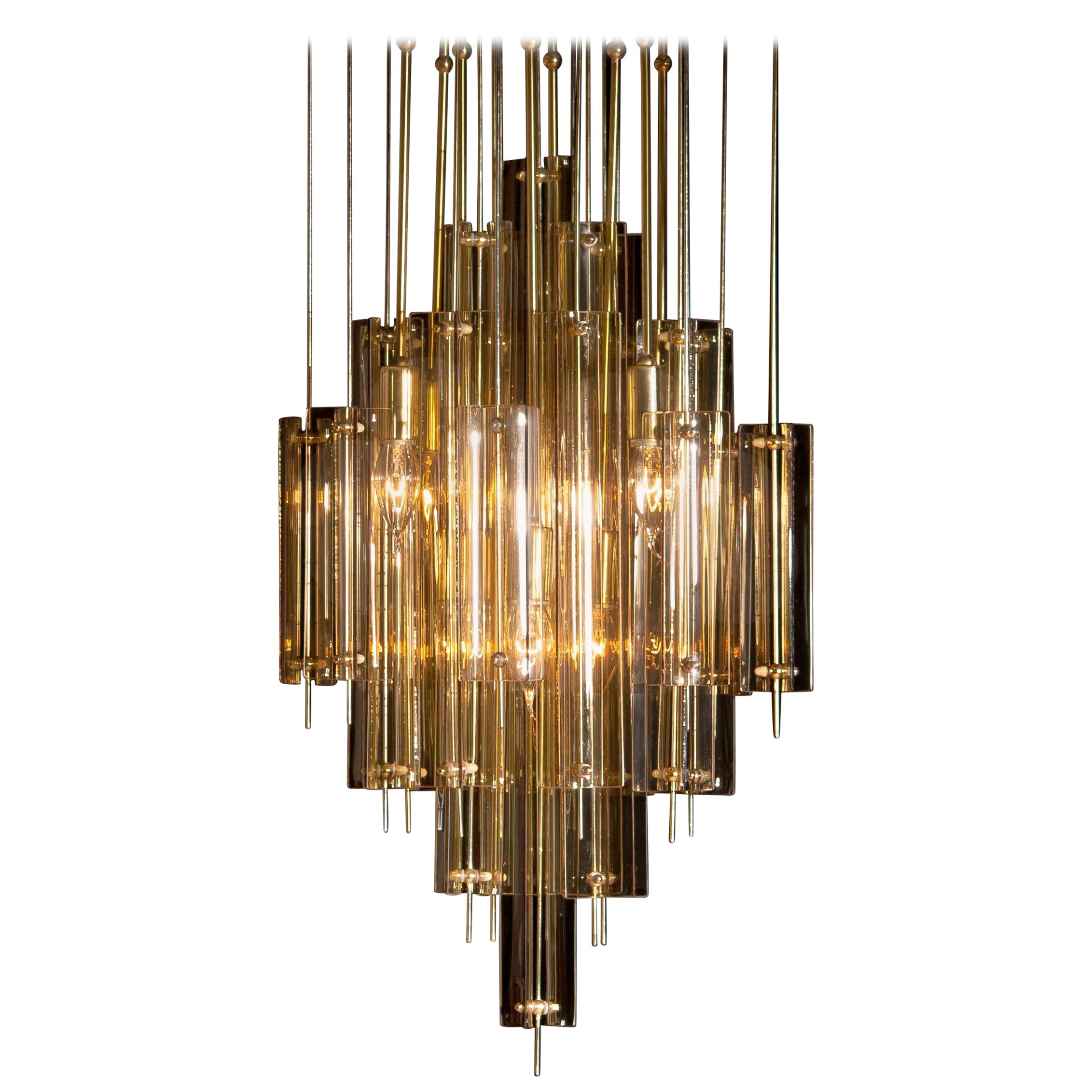 Beautiful brass chandelier by Verner Panton with smoked glass elements.
Build up with eight fittings size: E14 / 17 suits 110 / 230 volts and technically 100%.
Overall impression is good.
Period 1960s.
  