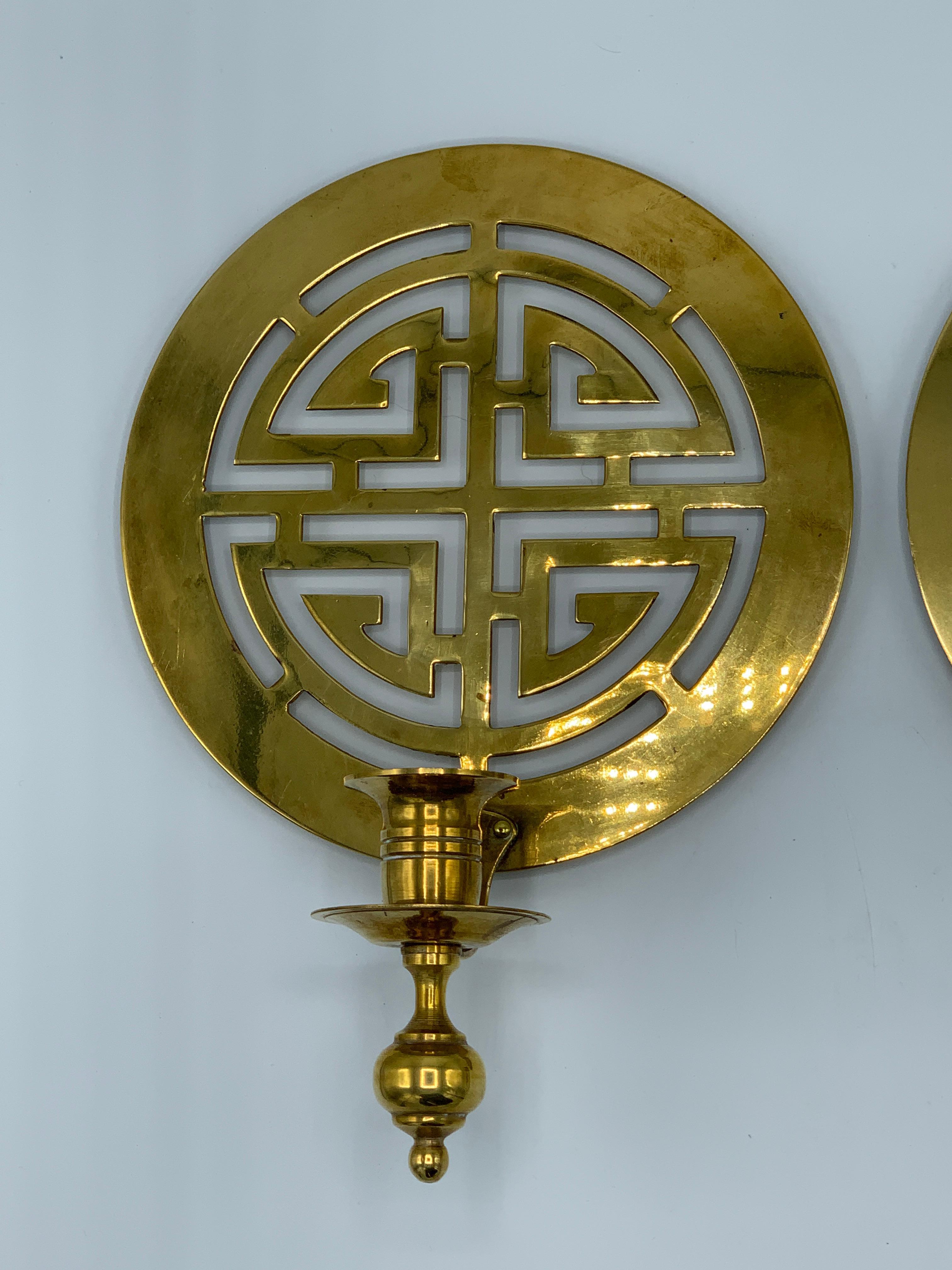 Offered is a gorgeous, pair of 1960s polished-brass chinoiserie candlestick wall sconces. The pair each has mounting hardware on the backside and could easily be professionally wired for electric use. Heavy, weighs 3.5lbs total for the pair.