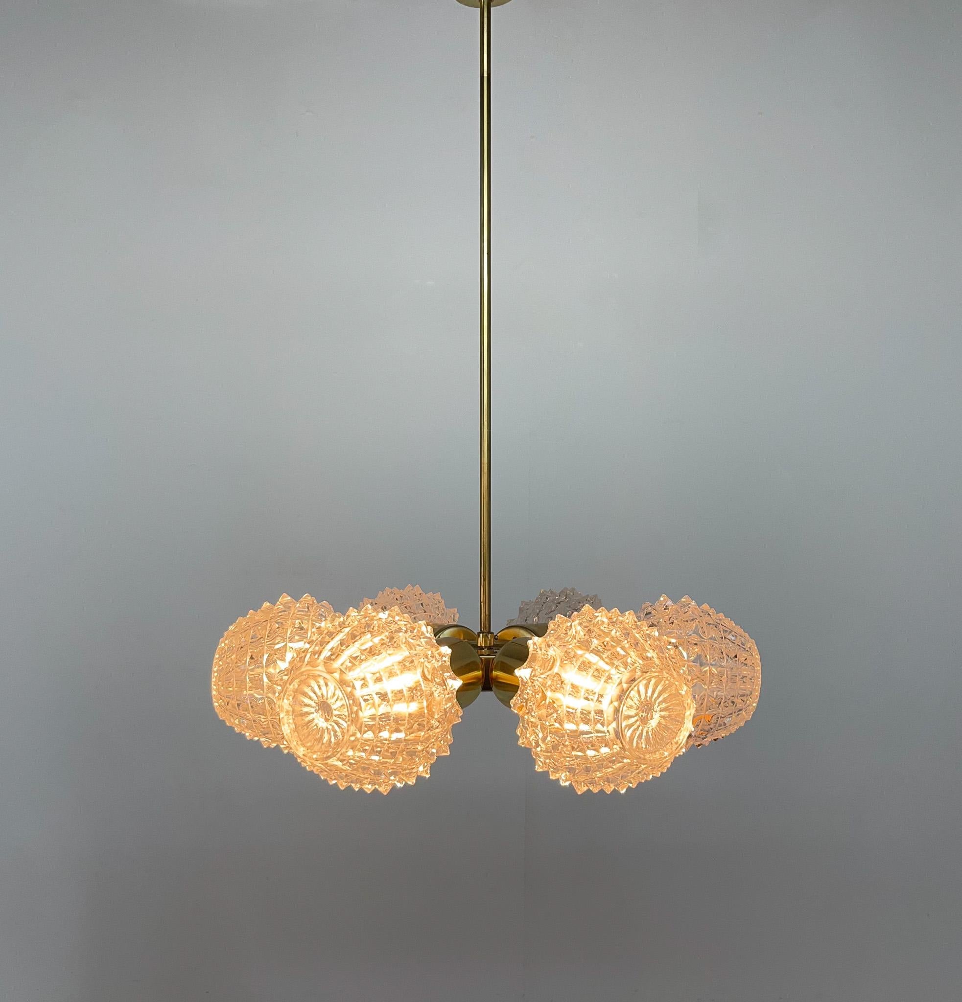 Set of two midcentury chandeliers by Kamenický Šenov Glassworks (famous glassworks in Czechoslovakia). Made of brass and glass. 
Very good vintage condition. 
Sold separetely, price is per one item. 
Bulbs: 6x E 14.