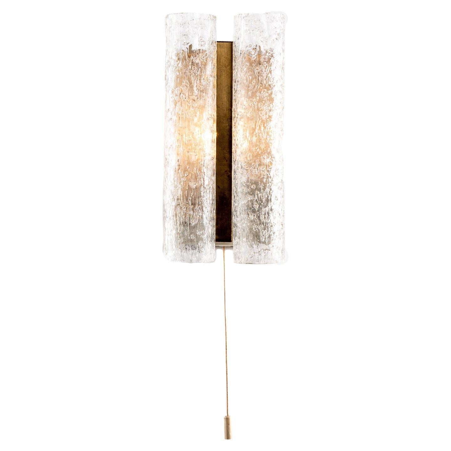 If you like vintage lighting then you will love this Doria glass sconce. Designed with two vertical tubes astride brass plates and metal centre-plate, it's a highly distinctive piece and looks stunning when illuminated. Recently fitted new wiring