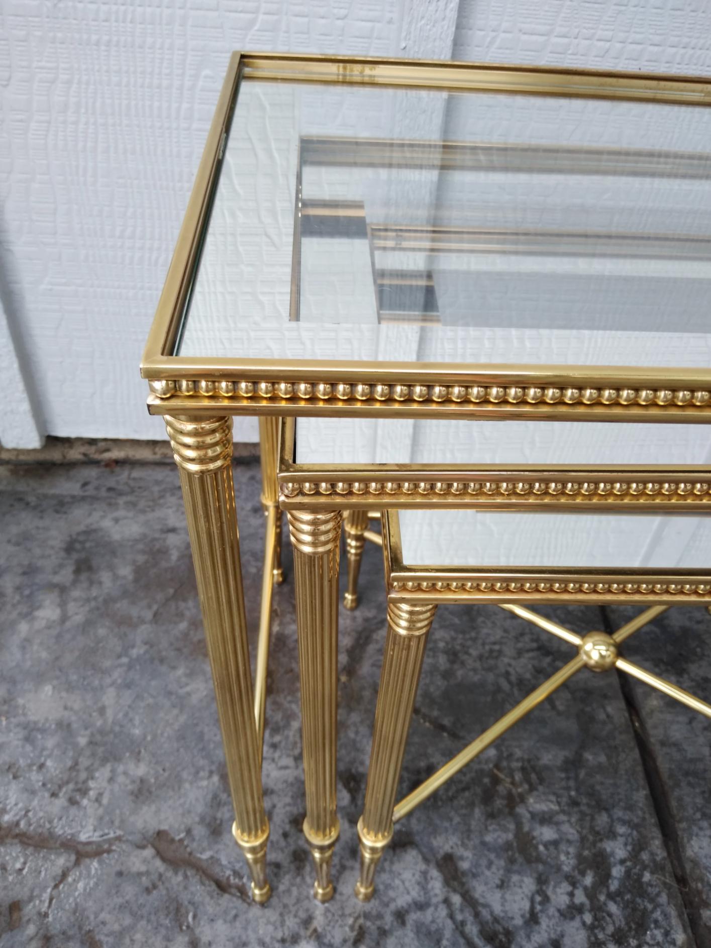 Fabulous set of brass nesting tables by Maison Jansen of France, circa 1960s.
These are exceptional solid brass tables with mirror trimmed glass top.
Condition is just about flawless, ready to place in your decor.