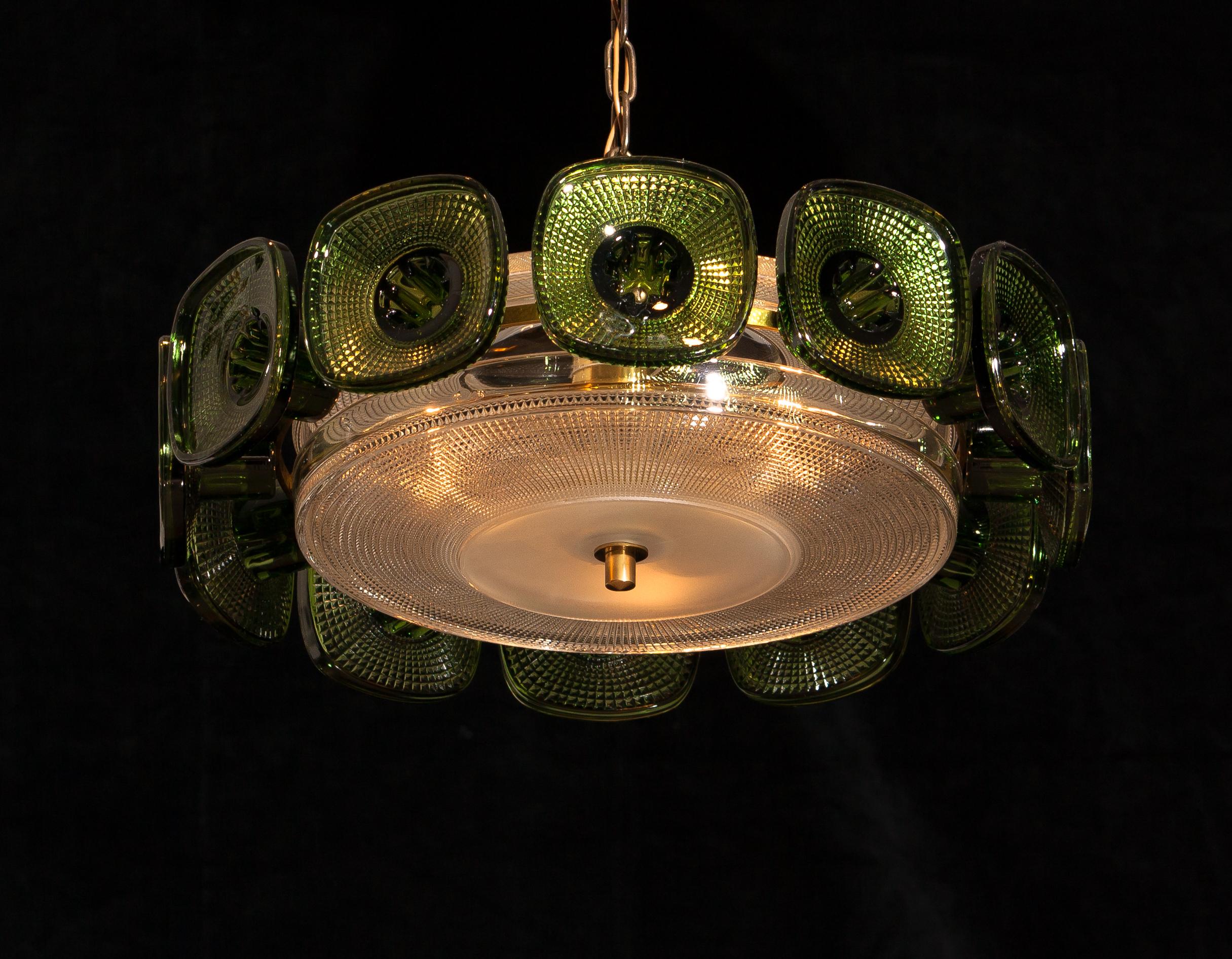 Extremely beautiful pendant/chandelier in clear and bottle green crystal made by Orrefors Sweden and designed by Carl Fagerlund.
This pendant is in excellent condition and technical 100%.
Three E14 sockets for 220 / 110-volt wire.
Period
