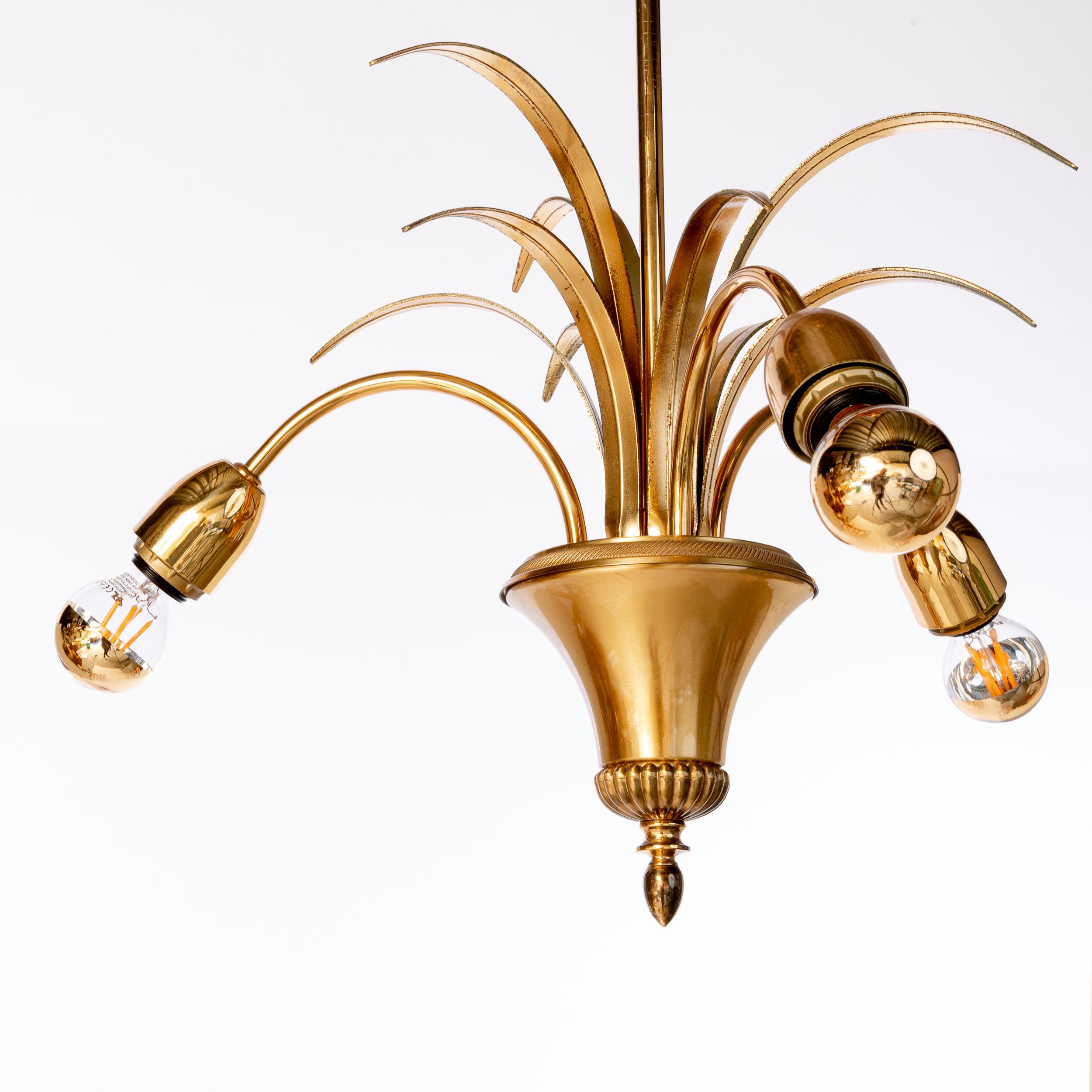 Wonderfull palm pendant with nine brass leaves and three arms with each a E14 socket.