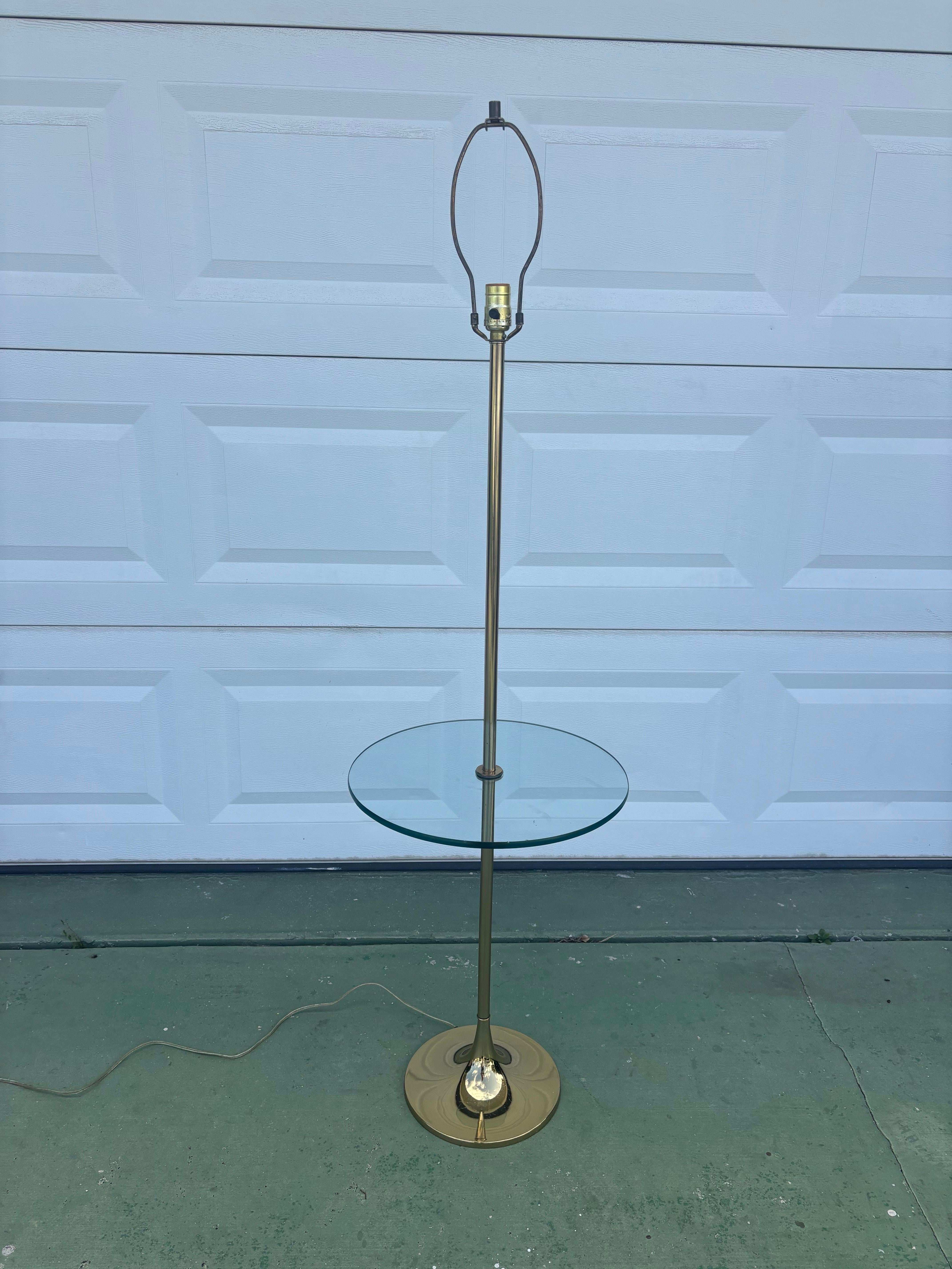 Elegant floor lamp with glass table by Bill Curry for Laurel Lamps. A classic mid century modern tulip style base forming a thin sleek stem supporting the lamp. In the middle is a floating glass table top. 

Excellent construction and made to last.