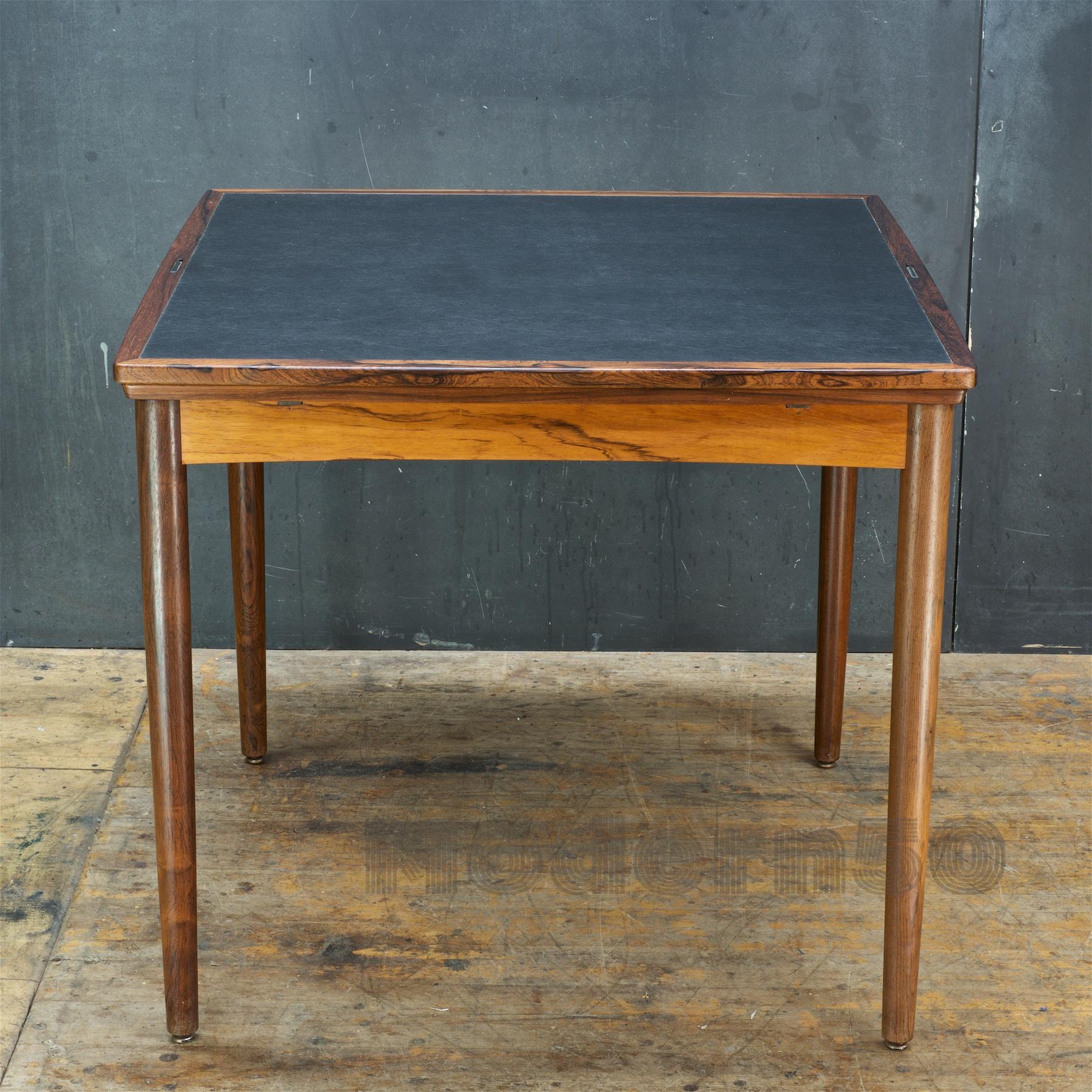 A wonderful and simple Danish design. A compact apartment sized 31.5 inch square table that has two 12.25 inch leaves that can extend independently or together to tightly sandwich the center panel to 56.38 inches.