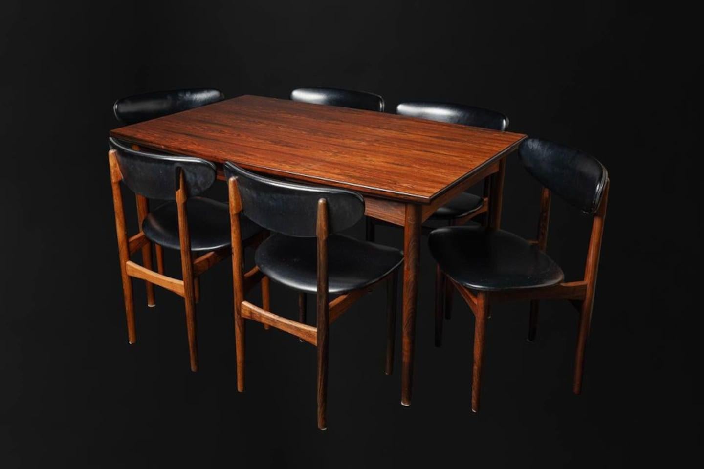 Exceptional Brazilian rosewood dining set made in Denmark in the early 1960s, this lovely seat features a draw leaf dining table and set of six chairs. The dining table is freshly restored and showcases exquisite graining of a rare wood that is no