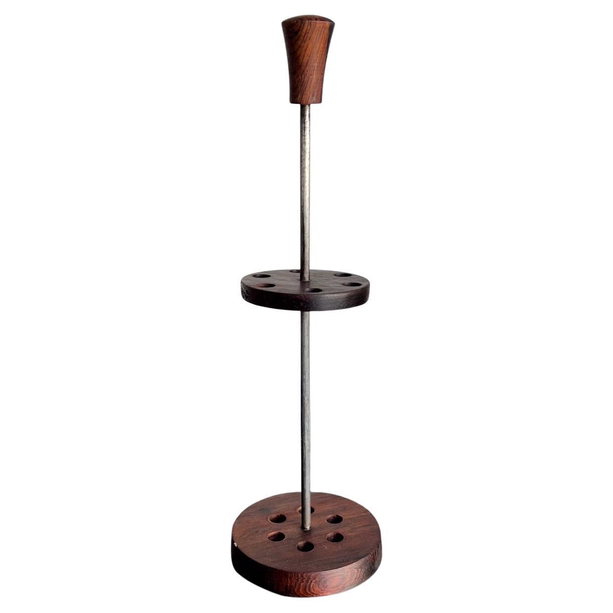 Vintage Rosewood Holder Stand (up to 6 item holder-small utensils forks)
Brazilian rosewood and iron. Possibly Brazil 1960s. 
No forks -utensils included.
10.75 h x 3.25 diameter
Preowned vintage condition
Refer to images