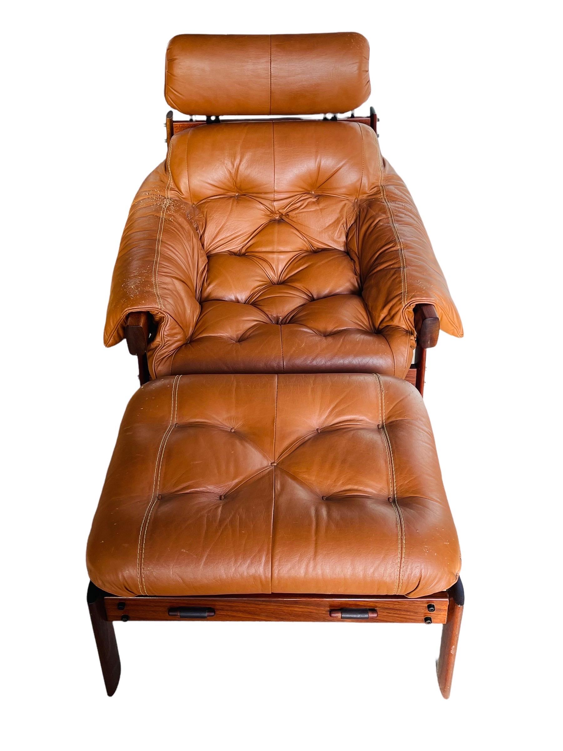 This stunning Brazilian Rosewood armchair and ottoman was designed by Percival Lafer in the 1960s. The solid Rosewood frame carrie’s the smooth leather tufted upholstery with leather straps on the back. Both the frame and cognac leather are in good