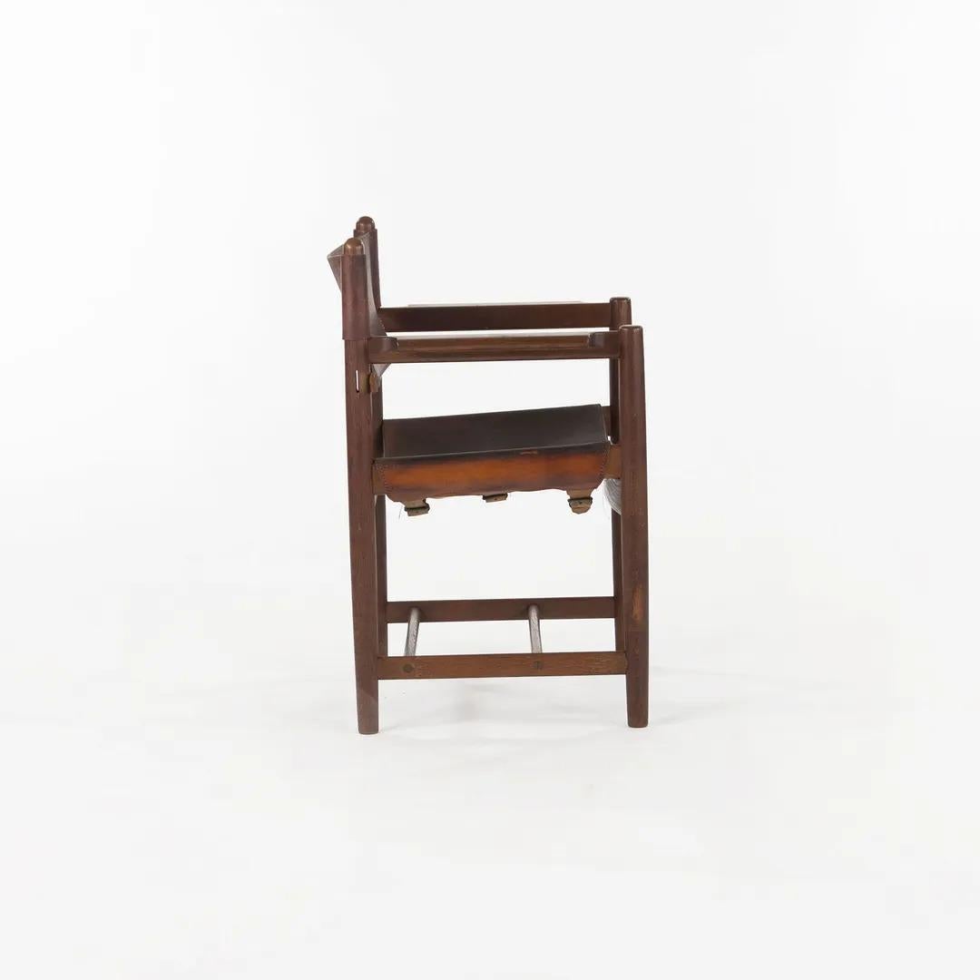 This is a Model 3238 Spanish Dining Chair. It features a brawny quarter-sawn solid oak frame, with a thick slung saddle-leather seat and backrest. It was designed by the great Danish designer Børge Mogensen in 1958 and manufactured by CI designs. CI