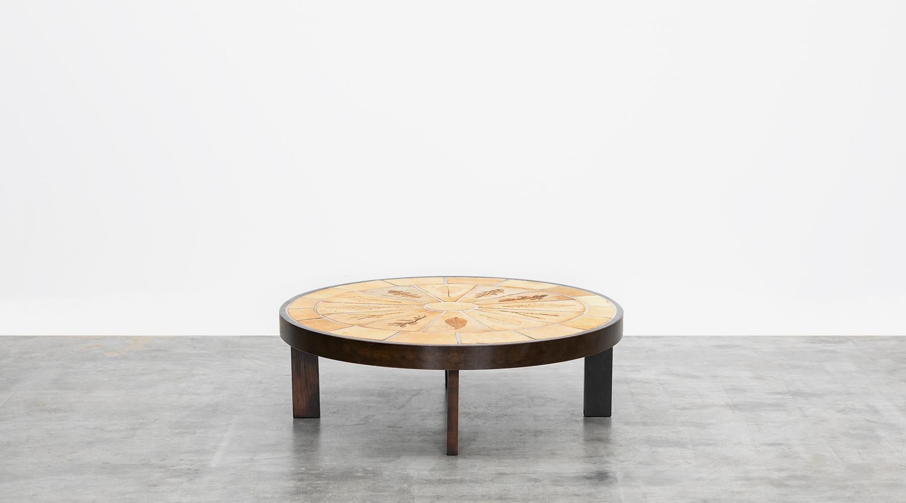 Timeless coffee table designed by Roger Capron. It comes in a wooden frame, the table top in ceramic is in outstanding condition and is signed by the designer. Decorated with pretty leaf pattern. The table is manufactured by Vallauris.

Capron was