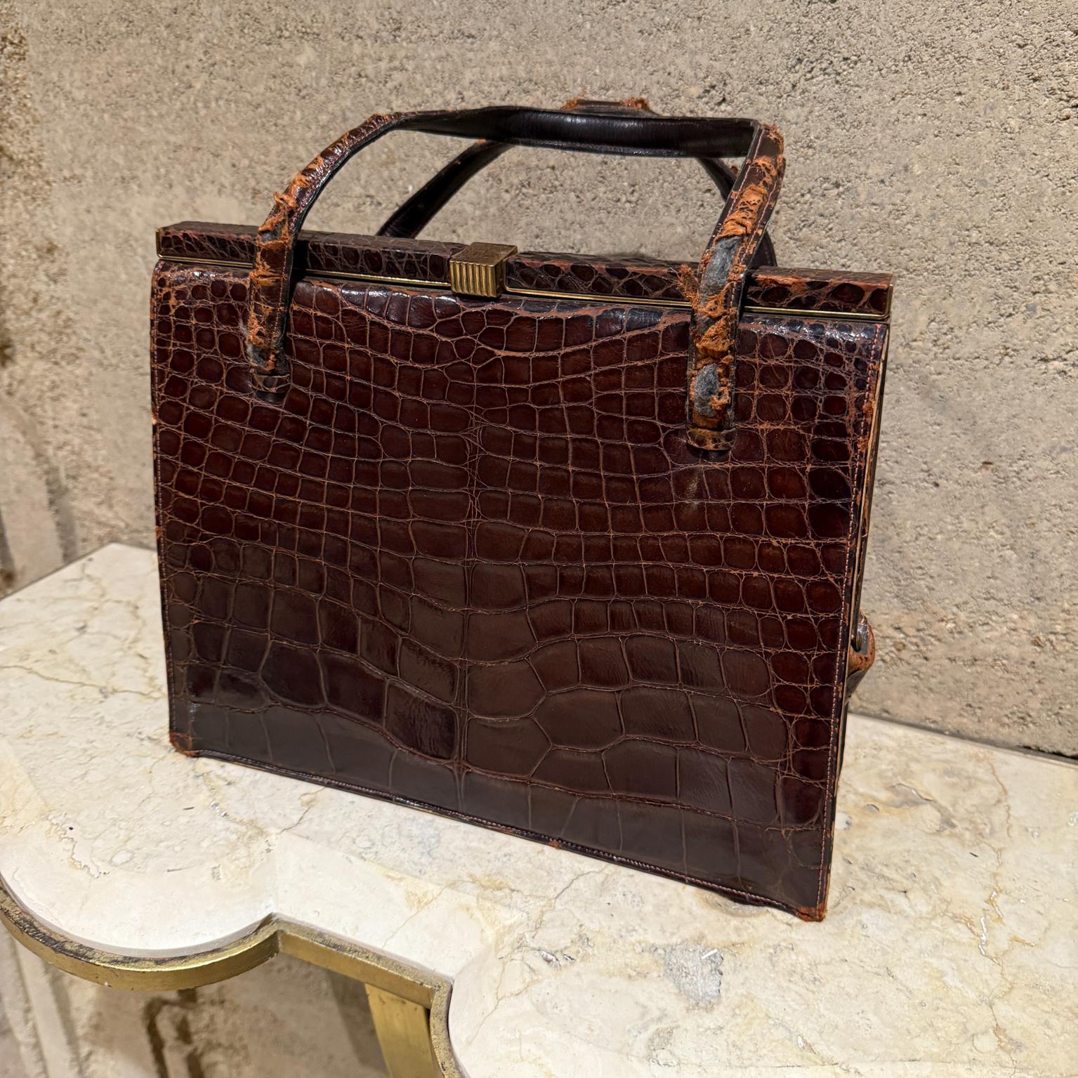 1960s Brown crocodile Bag Deauville
pocketbook tote purse bag
maker stamp Deauville made USA
15.25 h to handle 9.75 h x 12 w x 3
Preowned vintage unrestored tattered wear present
Refer to all listed images