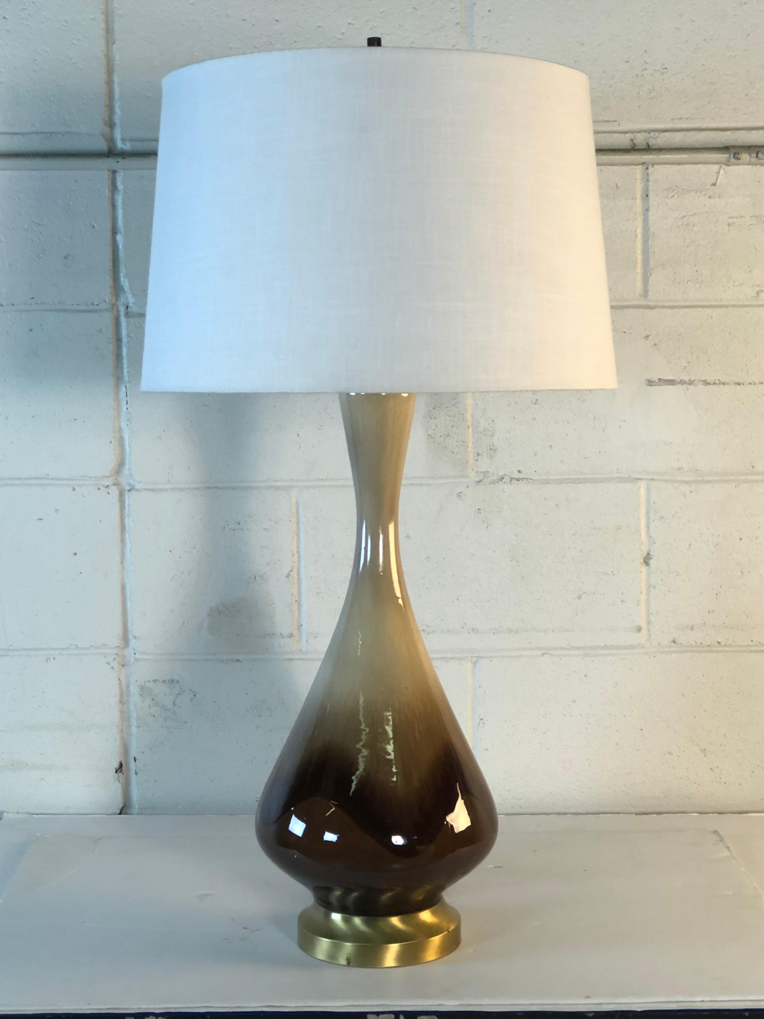 Vintage 1960s ceramic brown drip glaze table lamp with a brushed gold metal base. The lamp is wired for the US and in working condition. Harp, 4” diameter x 9” height. Socket, 24.5” H. No marks. Excellent condition.