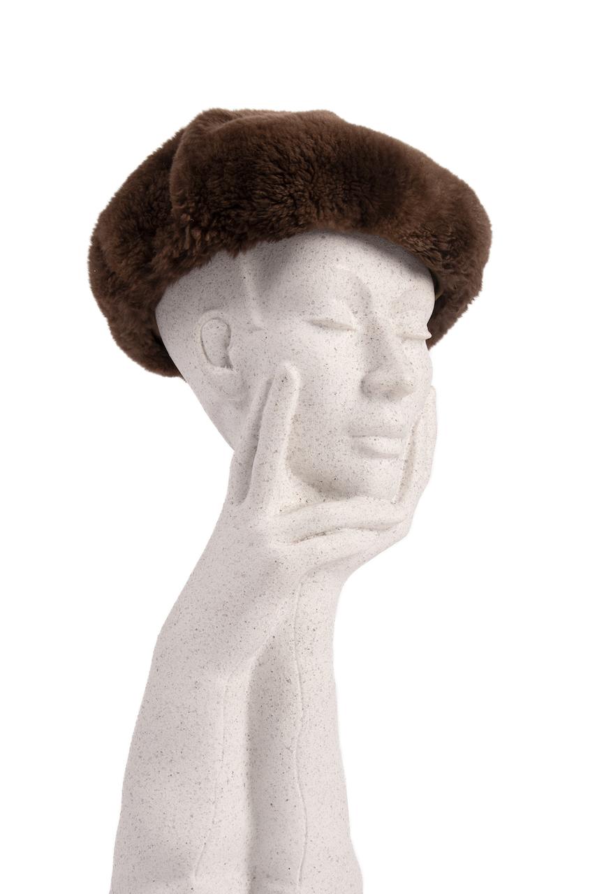 This is a chic soft, round and flat-crowned walnut brown genuine fur beret from the 1960s. It is designed from what I believe is sheared beaver fur.

Brown satin interior band and fully lined in a caramel acetate. The light-weight fur is incredibly