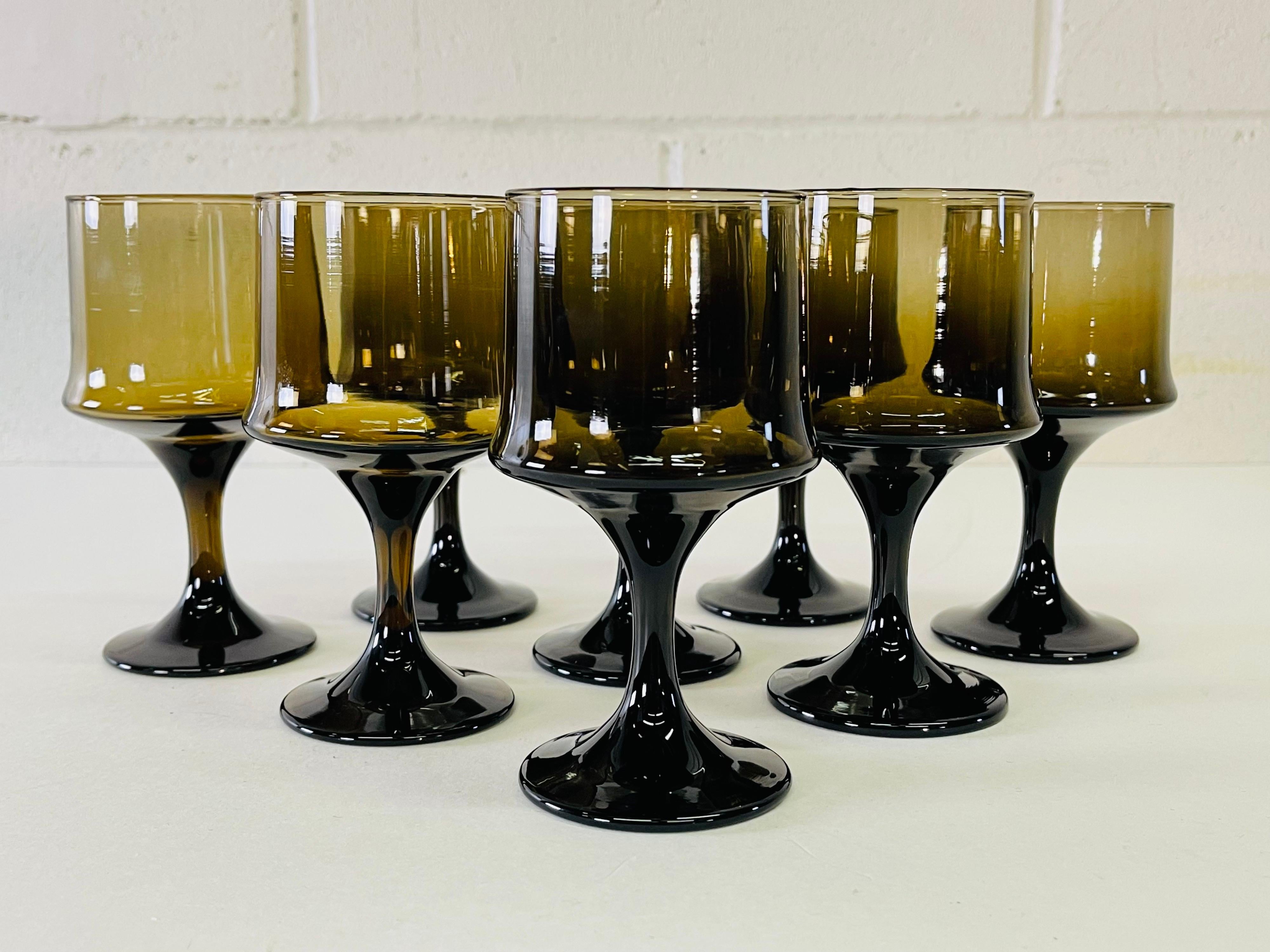 Vintage 1960s set of eight brown glass wine stems. No marks.