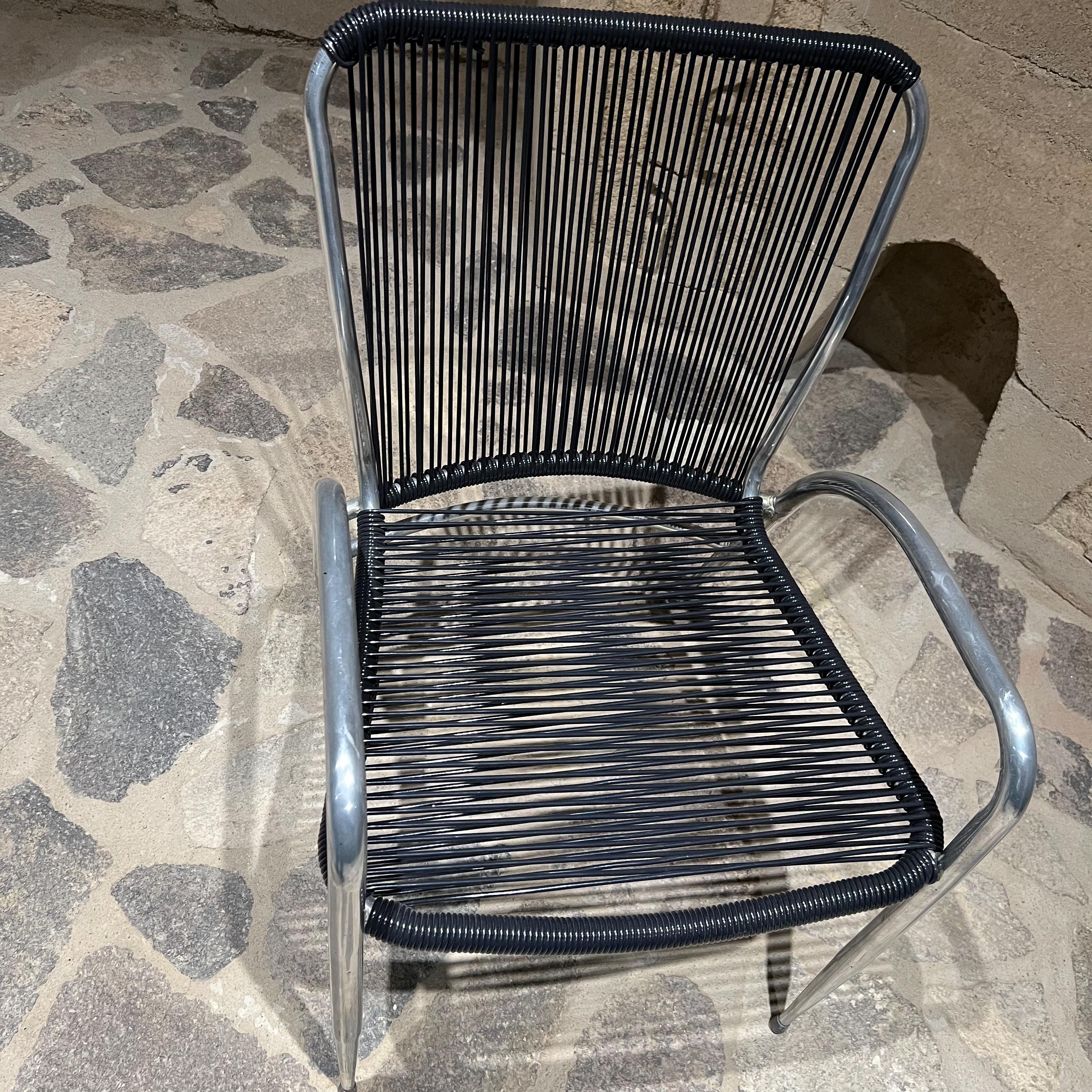 Sculptural Patio chairs
1960s set of two sculptural patio chairs by Brown Jordan in Polished Aluminum and new woven black plastic. 
Designed after Walter Lamb
Measures: 30.75 H x 20.25 W x 24.75 D, Seat 15.5 Arm 20.75
Preowned vintage condition