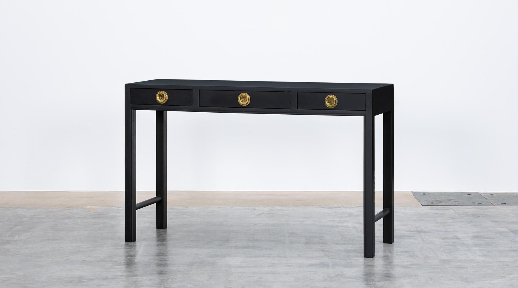 Dark brown, mahogany, brass handles, console by Edward Wormley for Dunbar, USA, 1960s.

Plain and sleek design with three drawers with brass handles. Very elegantly worked console in mahogany. The style is rather untypical for Wormley and is more